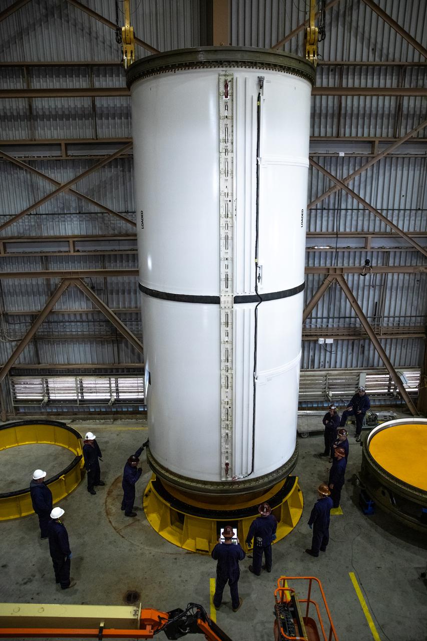 Engineers and technicians process the right forward center segment of the Space Launch System solid rocket boosters for the Artemis II mission inside the Rotation, Processing and Surge Facility (RPSF) at NASA’s Kennedy Space Center in Florida on Tuesday, Nov. 27, 2023.   The team has been examining the 10 booster segments one-by-one then lifting them to make sure they are ready for integration and launch before moving them to the Vehicle Assembly Building for stacking atop the mobile launcher. Artemis II astronauts Reid Wiseman, Victor Glover, Christina Koch, and Jeremy Hansen will blast off from Kennedy and travel around the moon for the agency’s first crewed mission under Artemis that will test all of the Orion spacecraft’s systems.