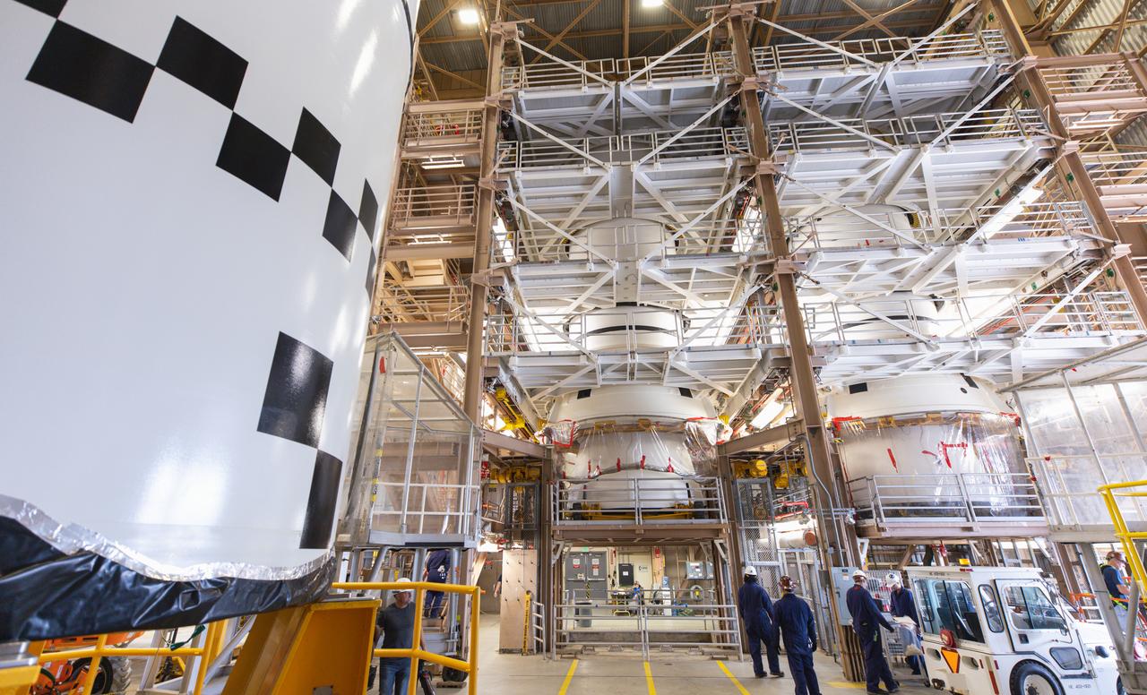 Technicians with Exploration Ground Systems perform inspections of the Northrop Grumman-manufactured two aft exit cones on Wednesday, Dec. 13, 2023, inside the Rotation, Processing and Surge Facility (RPSF) at NASA’s Kennedy Space Center in Florida before mating processes begin for the agency’s Artemis II mission. The aft exit cones are attached to the bottom piece of the two boosters, (seen here in these photos), which is called the aft segment, and the exit cones act like a battery pack to provide added thrust for the boosters while protecting the aft skirts from thermal environment during launch of the agency’s first crewed mission under Artemis that will test all of the Orion spacecraft systems.