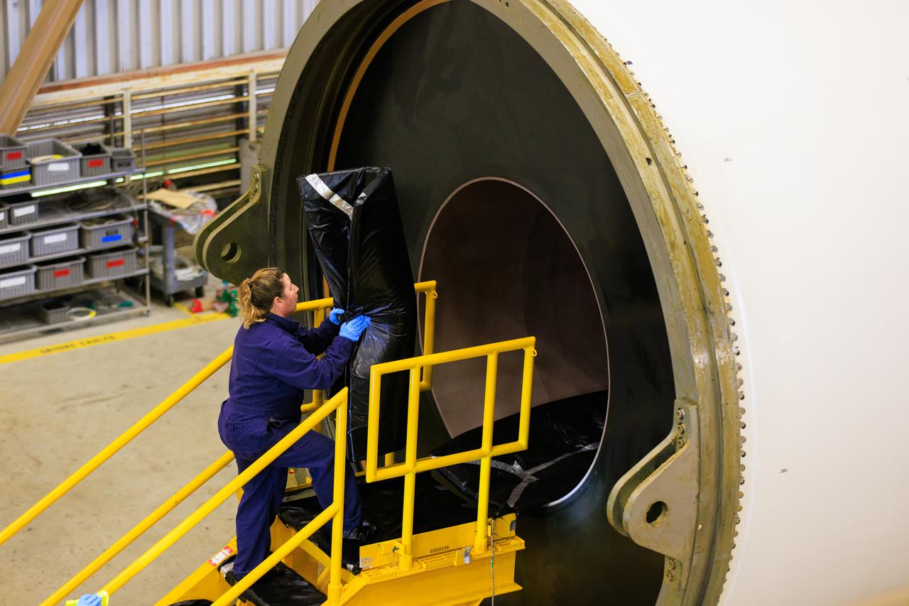 Technicians with Exploration Ground Systems, based at NASA’s Kennedy Space Center in Florida, perform propellant grain inspections on two of the agency’s Space Launch System solid rocket booster segments for the Artemis II campaign on Wednesday, Dec. 20, 2023, inside the Rotation, Processing and Surge Facility. The team is inspecting the propellant   of all 10 booster segments before they are rotated vertically for processing. The Artemis II mission will send four astronauts around the Moon as part of the agency’s effort to establish a long-term science and exploration presence at the Moon, and eventually Mars. 