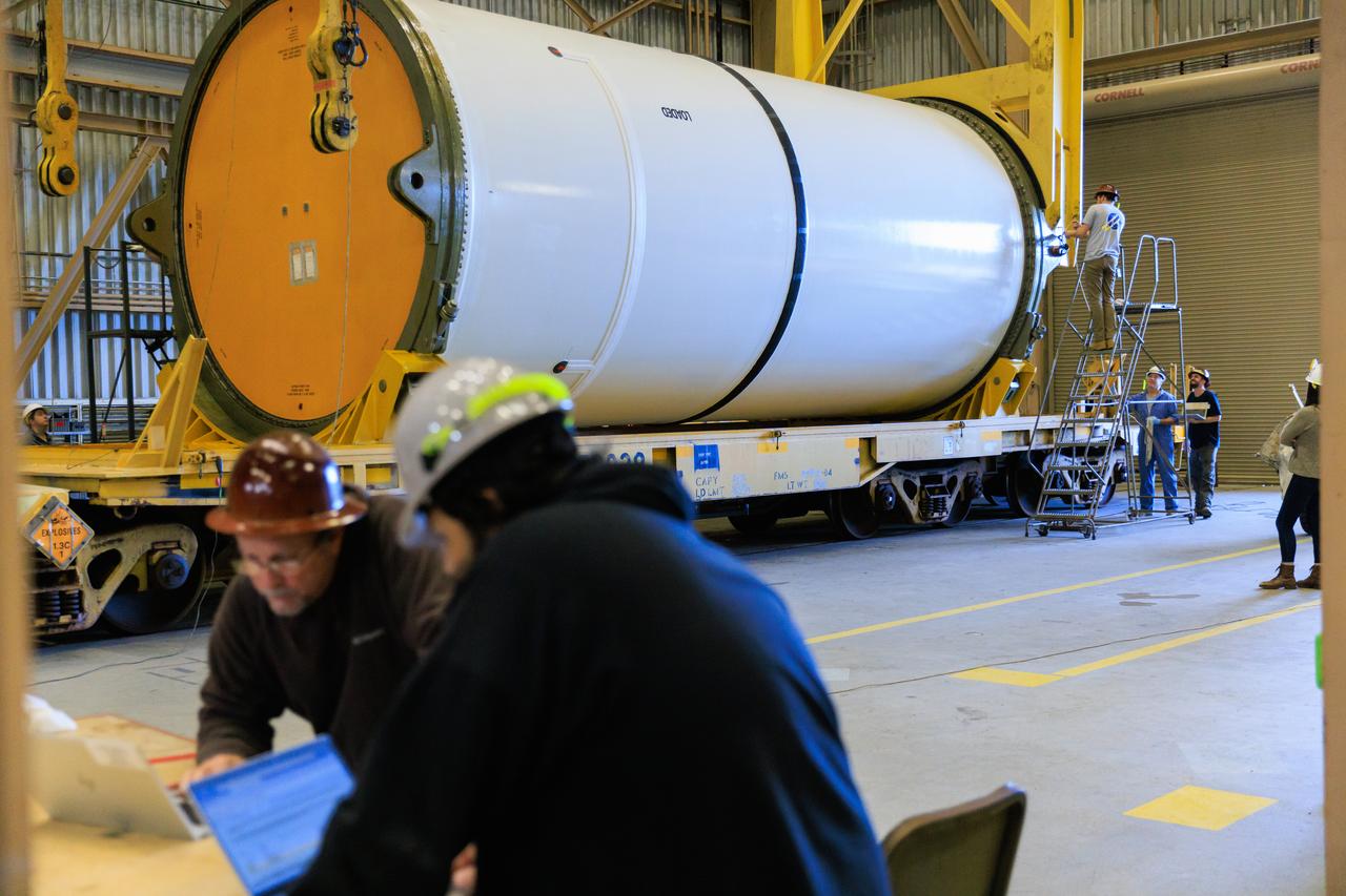 Following the successful propellant grain inspection of two segments of the solid rocket boosters for NASA’s Space Launch System inside the Rotation, Processing and Surge Facility at NASA’s Kennedy Space Center in Florida, crews on Thursday, Dec. 21, 2023, rotate and lift the segments from horizontal into a vertical position in preparation for the agency’s Artemis II launch campaign.  The Artemis II mission will send four astronauts around the Moon as part of the agency’s effort to establish a long-term science and exploration presence at the Moon, and eventually Mars. 