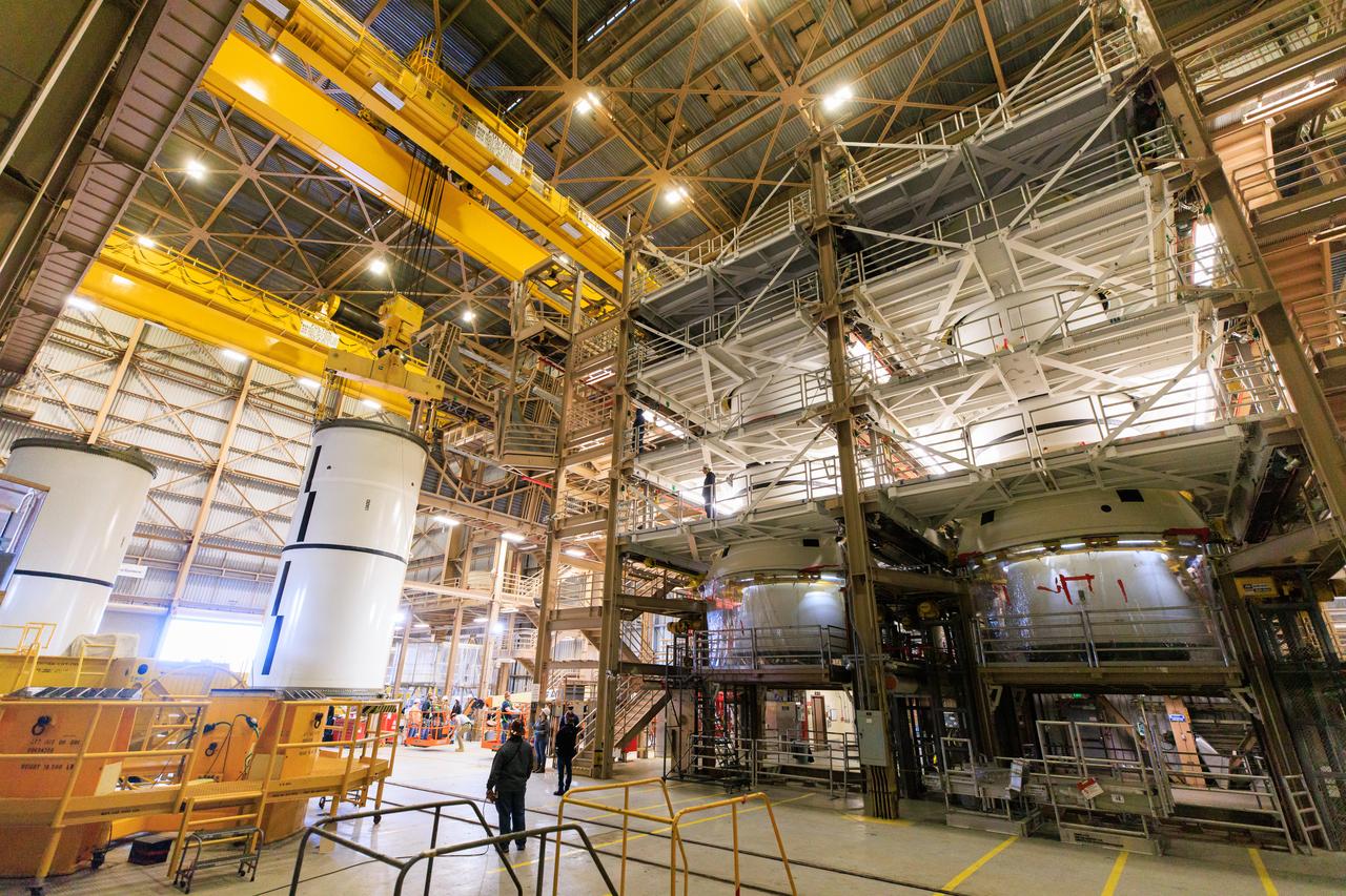 Following the successful propellant grain inspection of two segments of the solid rocket boosters for NASA’s Space Launch System inside the Rotation, Processing and Surge Facility at NASA’s Kennedy Space Center in Florida, crews on Thursday, Dec. 21, 2023, rotate and lift the segments from horizontal into a vertical position in preparation for the agency’s Artemis II launch campaign.  The Artemis II mission will send four astronauts around the Moon as part of the agency’s effort to establish a long-term science and exploration presence at the Moon, and eventually Mars. 
