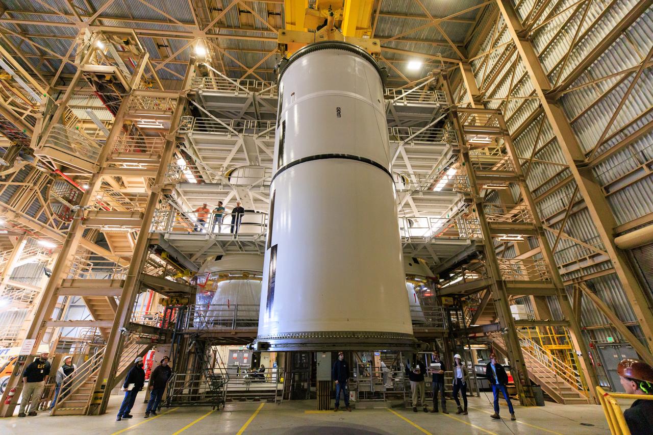 Following the successful propellant grain inspection of two segments of the solid rocket boosters for NASA’s Space Launch System inside the Rotation, Processing and Surge Facility at NASA’s Kennedy Space Center in Florida, crews on Thursday, Dec. 21, 2023, rotate and lift the segments from horizontal into a vertical position in preparation for the agency’s Artemis II launch campaign.  The Artemis II mission will send four astronauts around the Moon as part of the agency’s effort to establish a long-term science and exploration presence at the Moon, and eventually Mars. 