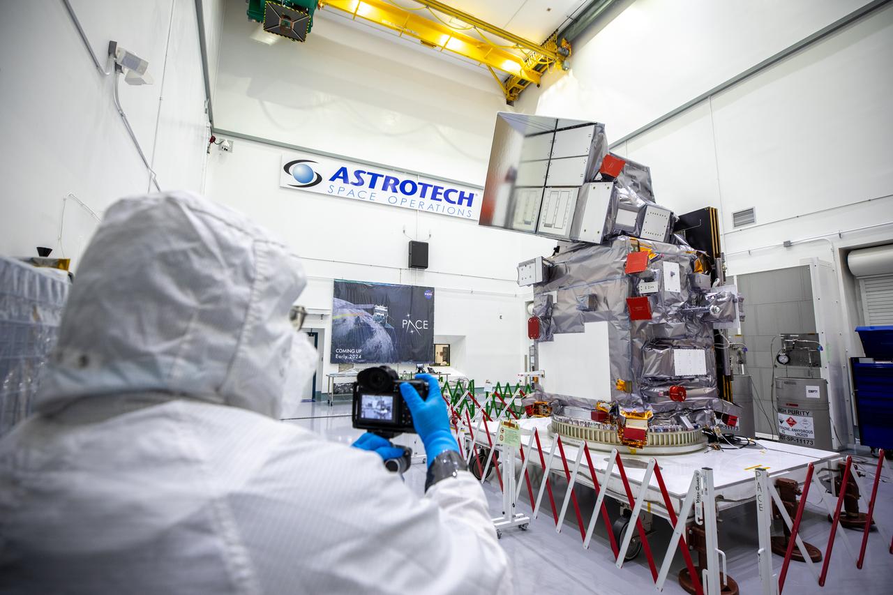 Members of the media photographed NASA’s PACE (Plankton, Aerosol, Cloud, ocean Ecosystem) spacecraft on Wednesday, Jan. 3, 2024, inside a cleanroom at the Astrotech Space Operations Facility near NASA’s Kennedy Space Center in Florida. NASA invited journalists for the opportunity to speak with mission subject matter experts and view the spacecraft before it is encapsulated into its payload fairing for its launch aboard a SpaceX Falcon 9 rocket no earlier than Tuesday, Feb. 6, 2024, from Space Launch Complex 40 at Cape Canaveral Space Force Station in Florida.