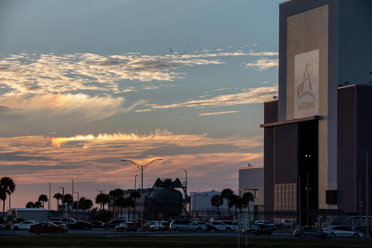 Photographers at NASA capture the sunset on Tuesday, Jan. 30, 2024, near Vehicle Assembly Building at the agency’s Kennedy Space Center in Florida. The iconic Vehicle Assembly Building, completed in 1966 and currently used for assembly of NASA’s Space Launch System rocket for Artemis missions, remains the only building in which rockets were assembled that carried humans to the surface of another world.