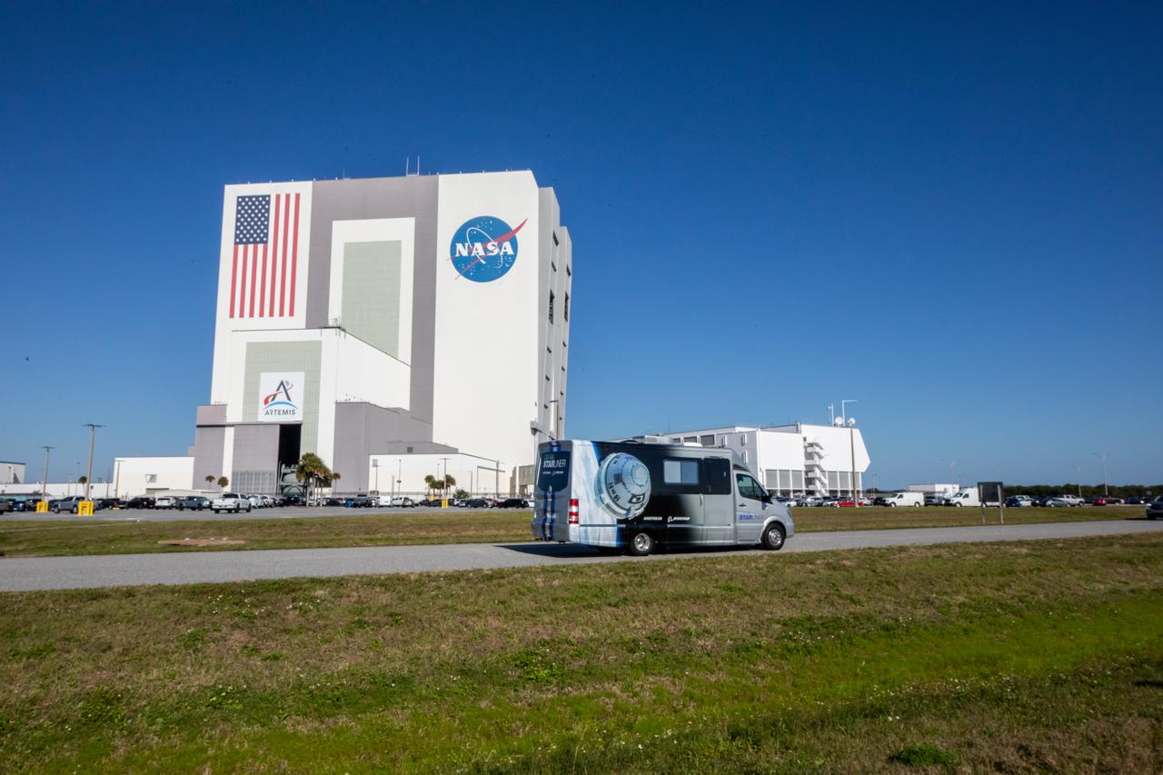 A crew transportation vehicle carrying NASA astronauts Suni Williams and Barry “Butch” Wilmore drives past the iconic Vehicle Assembly Building at the agency’s Kennedy Space Center in Florida on Wednesday, Jan. 31, 2024, as part of an integrated crew exercise simulation for NASA’s Boeing Crew Flight Test (CFT). The integrated exercise involved participation from the flight crew, NASA, Boeing, and United Launch Alliance (ULA), and allowed teams to rehearse prelaunch operations beginning roughly four hours before a targeted liftoff. CFT will be the first flight with astronauts to the International Space Station for Boeing’s Starliner spacecraft as part of NASA’s Commercial Crew Program. Starliner is scheduled to launch atop ULA’s Atlas V rocket no earlier than mid-April 2024.