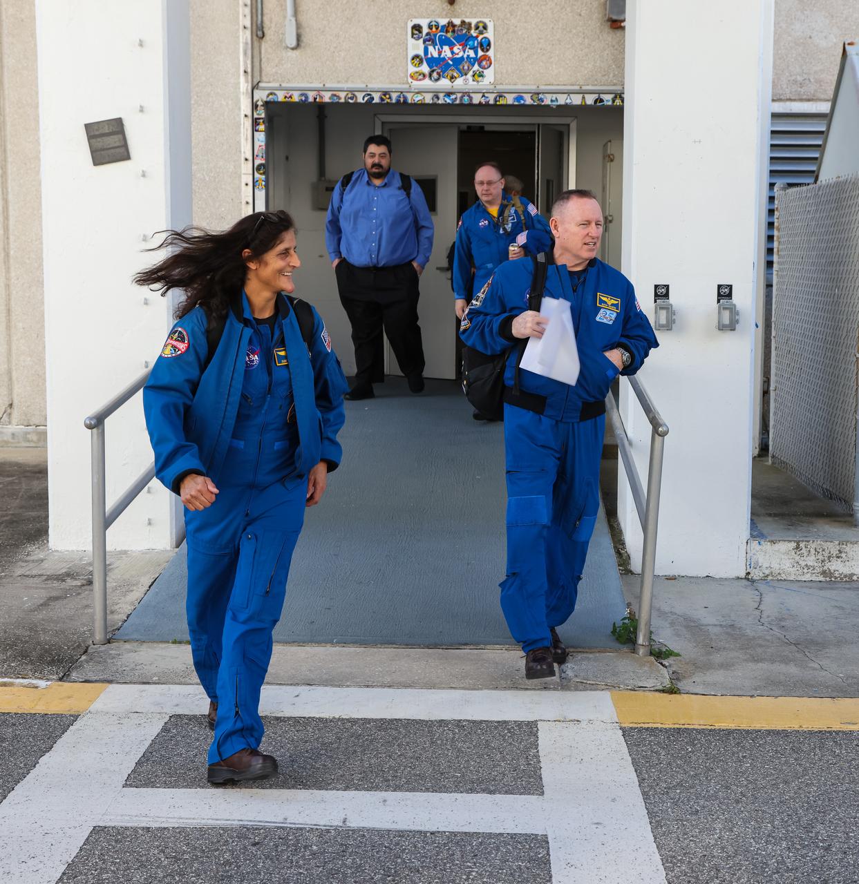 NASA astronauts Suni Williams and Barry “Butch” Wilmore emerge from the Neil Armstrong Operations and Checkout Building at the agency’s Kennedy Space Center in Florida on Wednesday, Jan. 31, 2024, as part of an integrated crew exercise simulation for NASA’s Boeing Crew Flight Test (CFT). The integrated exercise involved participation from the flight crew, NASA, Boeing, and United Launch Alliance (ULA), and allowed teams to rehearse prelaunch operations beginning roughly four hours before a targeted liftoff. CFT will be the first flight with astronauts to the International Space Station for Boeing’s Starliner spacecraft as part of NASA’s Commercial Crew Program. Starliner is scheduled to launch atop ULA’s Atlas V rocket no earlier than mid-April 2024.