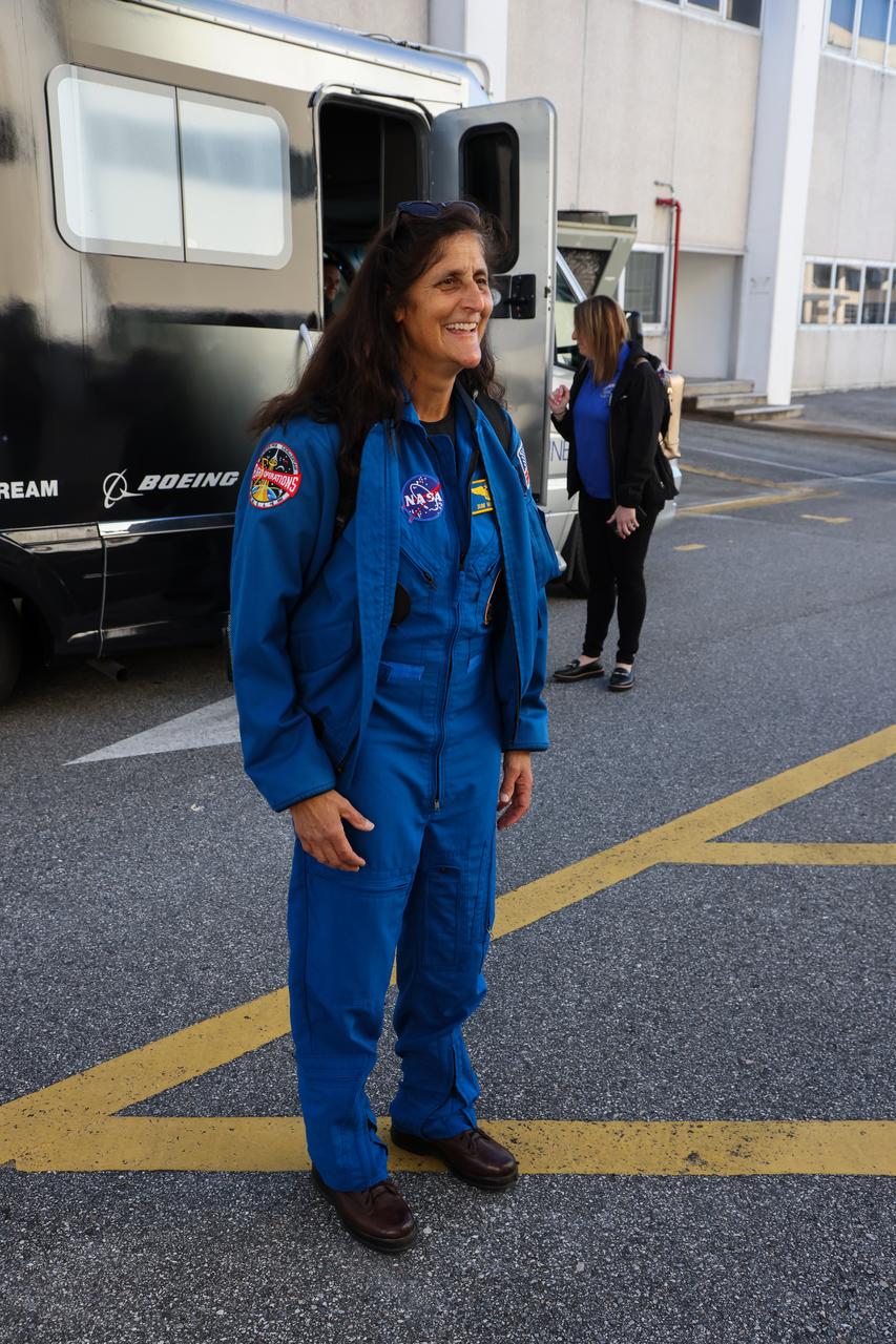 NASA astronaut Suni Williams emerges from the Neil Armstrong Operations and Checkout Building at the agency’s Kennedy Space Center in Florida on Wednesday, Jan. 31, 2024, as part of an integrated crew exercise simulation for NASA’s Boeing Crew Flight Test (CFT). Williams and fellow crew member Barry “Butch” Wilmore, along with NASA, Boeing, and United Launch Alliance (ULA), participated in the integrated exercise, which allowed teams to rehearse prelaunch operations beginning roughly four hours before a targeted liftoff. CFT will be the first flight with astronauts to the International Space Station for Boeing’s Starliner spacecraft as part of NASA’s Commercial Crew Program. Starliner is scheduled to launch atop ULA’s Atlas V rocket no earlier than mid-April 2024.
