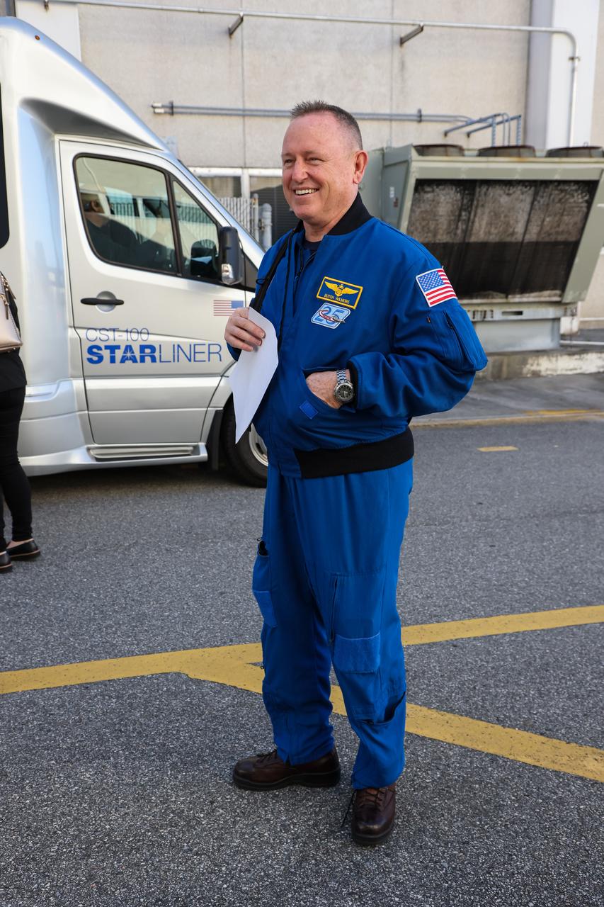 NASA astronaut Barry “Butch” Wilmore emerges from the Neil Armstrong Operations and Checkout Building and prepares to enter a crew transportation vehicle at the agency’s Kennedy Space Center in Florida on Wednesday, Jan. 31, 2024, as part of an integrated crew exercise simulation for NASA’s Boeing Crew Flight Test (CFT). Wilmore and fellow crew member Suni Williams, along with NASA, Boeing, and United Launch Alliance (ULA), participated in the integrated exercise, which allowed teams to rehearse prelaunch operations beginning roughly four hours before a targeted liftoff. CFT will be the first flight with astronauts to the International Space Station for Boeing’s Starliner spacecraft as part of NASA’s Commercial Crew Program. Starliner is scheduled to launch atop ULA’s Atlas V rocket no earlier than mid-April 2024.
