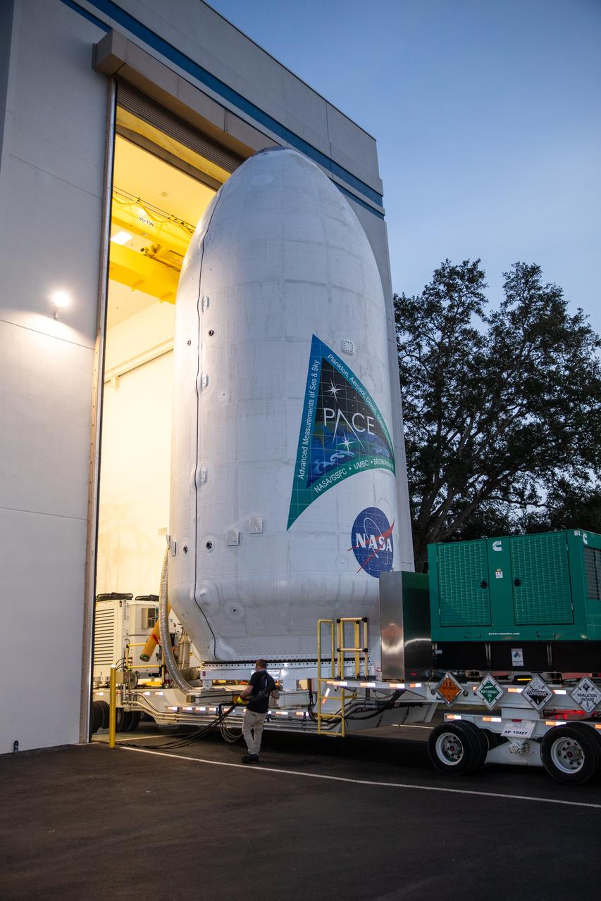 NASA’s PACE (Plankton, Aerosol, Cloud, ocean Ecosystem) spacecraft encapsulated inside SpaceX’s Falcon 9 payload fairings is transported from the Astrotech Space Operations Facility near the agency’s Kennedy Space Center in Florida to Space Launch Complex 40 at Cape Canaveral Space Force Station on Thursday, Feb. 1, 2024, to be mated with a SpaceX Falcon 9 in preparation for liftoff set for no earlier than 1:33 a.m. EST on Tuesday, Feb. 6, 2024. PACE is NASA’s newest earth-observing satellite that will help increase our understanding of Earth’s oceans, atmosphere, and climate by delivering hyperspectral observations of microscopic marine organisms called phytoplankton as well new data on clouds and aerosols.