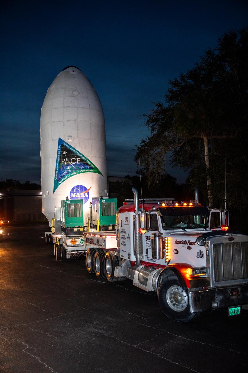 NASA’s PACE (Plankton, Aerosol, Cloud, ocean Ecosystem) spacecraft encapsulated inside SpaceX’s Falcon 9 payload fairings is transported from the Astrotech Space Operations Facility near the agency’s Kennedy Space Center in Florida to Space Launch Complex 40 at Cape Canaveral Space Force Station on Thursday, Feb. 1, 2024, to be mated with a SpaceX Falcon 9 in preparation for liftoff set for no earlier than 1:33 a.m. EST on Tuesday, Feb. 6, 2024. PACE is NASA’s newest earth-observing satellite that will help increase our understanding of Earth’s oceans, atmosphere, and climate by delivering hyperspectral observations of microscopic marine organisms called phytoplankton as well new data on clouds and aerosols.