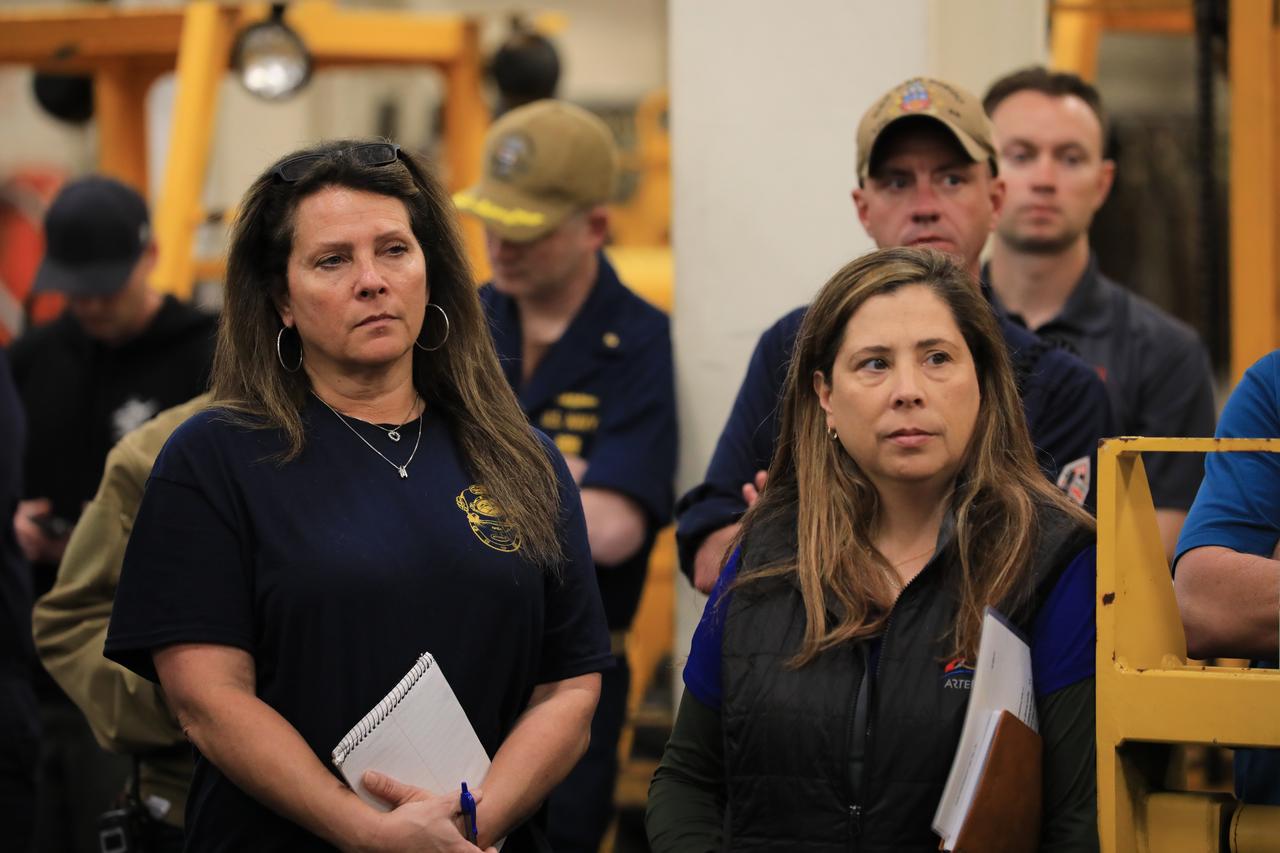 NASA Artemis Landing and Recovery Deputy Director Lisa Seiler (left) and NASA Artemis II Landing and Recovery Director Liliana Villarreal (right), along with members of NASA’s Exploration Ground System’s Landing and Recovery team and partners from the Department of Defense aboard the USS San Diego participate in a ship rider briefing on the flight deck prior to departure from Naval Base San Diego on Wednesday, Feb. 21, 2024. During this test campaign, teams will practice recovery procedures using the Crew Module Test Article, during Underway Recovery Test 11 (URT-11) off the coast of San Diego. URT-11 is the eleventh in a series of Artemis recovery tests, but the first time NASA and its partners from the Department of Defense put their Artemis II recovery procedures to the test with the astronauts.