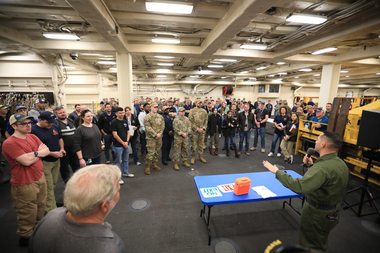 Members of NASA’s Exploration Ground System’s Landing and Recovery team and partners from the Department of Defense aboard the USS San Diego participate in a ship rider briefing on the flight deck prior to departure from Naval Base San Diego on Feb. 21. During this test campaign, teams will practice recovery procedures using the Crew Module Test Article, during Underway Recovery Test 11 (URT-11) off the coast of San Diego. URT-11 is the eleventh in a series of Artemis recovery tests, but the first time NASA and its partners from the Department of Defense put their Artemis II recovery procedures to the test with the astronauts.