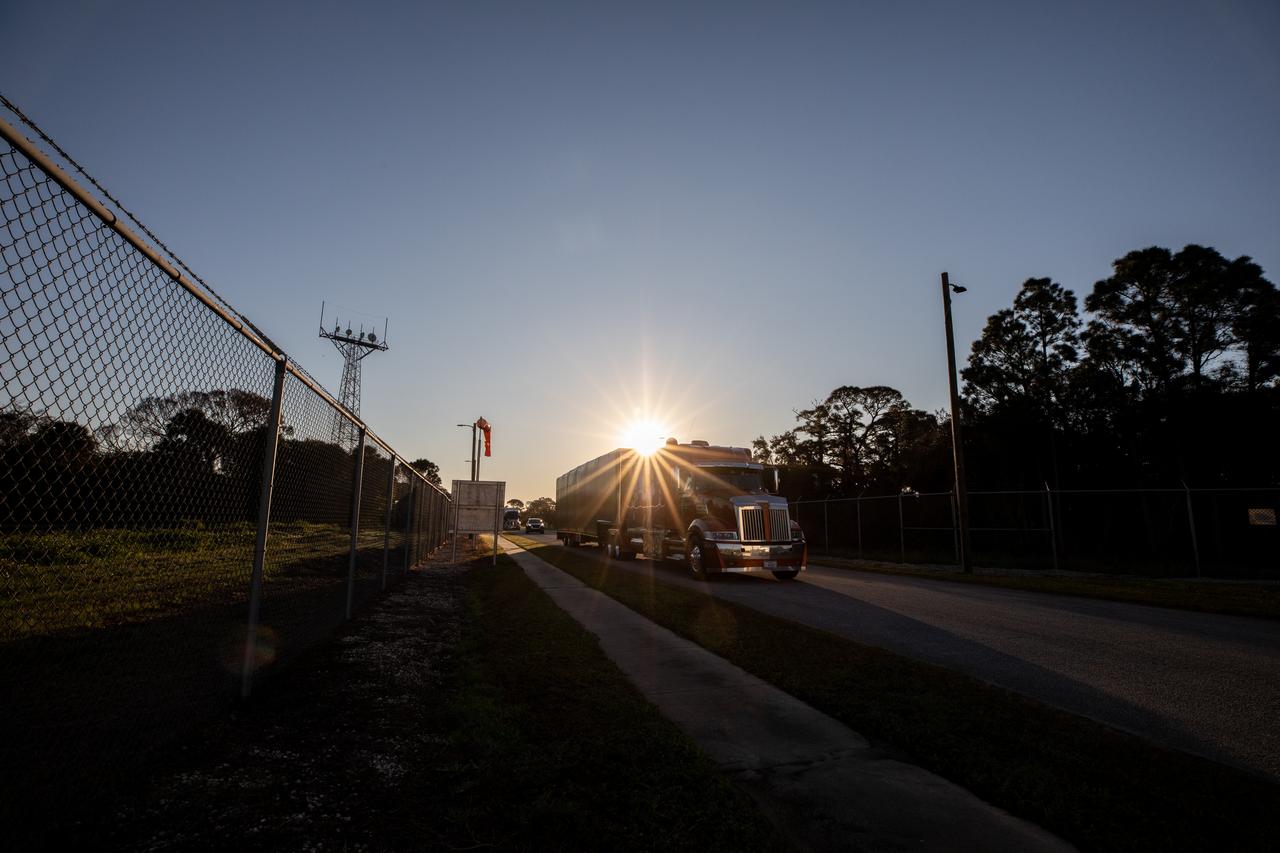 The transport carrier containing the five-panel solar arrays for NASA’s Europa Clipper spacecraft arrives at the Payload Hazardous Servicing Facility at the agency’s Kennedy Space Center in Florida on Wednesday, Feb. 21, 2024. The arrival completes the solar array journey which began in Leiden, Netherlands, where Airbus workers assembled them before shipping them by barge to Port of Miami in Florida and transporting them by truck to Kennedy. The solar arrays will attach to the spacecraft to power it on the 1.8-billion-mile journey to study Jupiter’s icy moon, Europa. Launch on a SpaceX Falcon Heavy rocket is no earlier than October 2024.