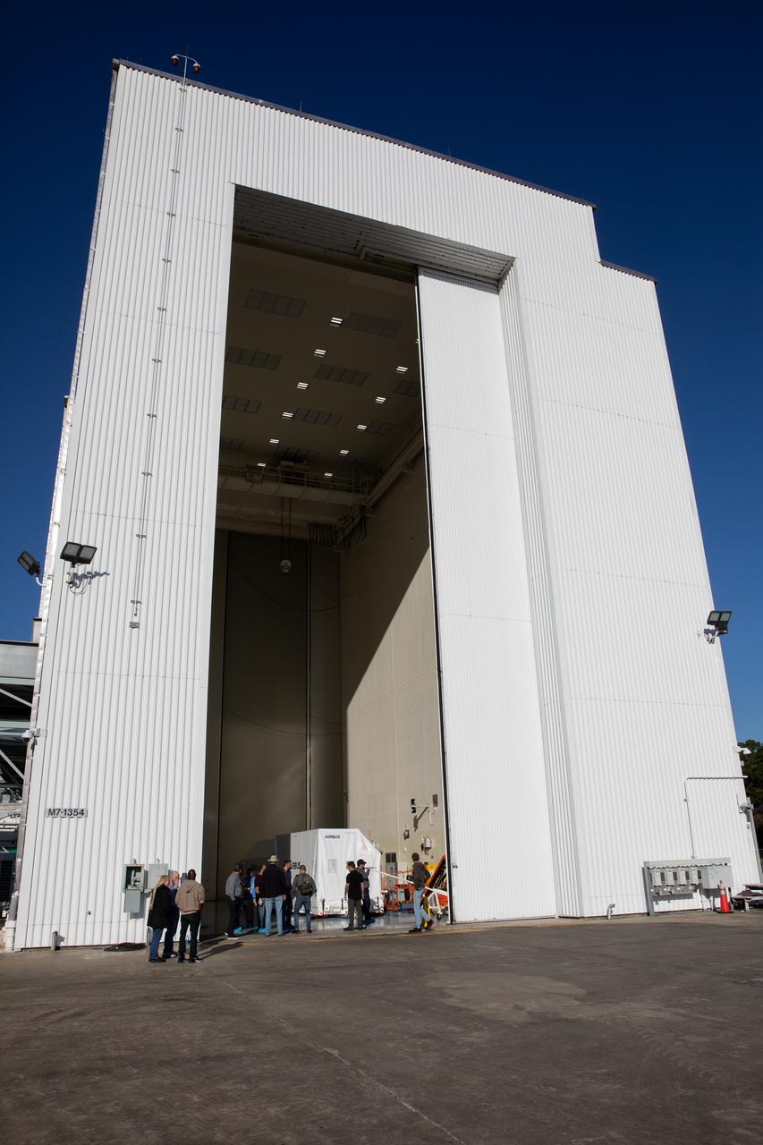 The transport carrier containing the five-panel solar arrays for NASA’s Europa Clipper spacecraft arrives at the Payload Hazardous Servicing Facility at the agency’s Kennedy Space Center in Florida on Wednesday, Feb. 21, 2024. The solar array travelled by air from Leiden, Netherlands, where Airbus workers assembled them over the last year, and then put on a barge to travel to the Port of Miami in Florida and loaded onto a semi-truck to be driven to Kennedy. The solar arrays will attach to the spacecraft to power it for the 1.8-billion-mile journey to study Jupiter’s icy moon, Europa. Launch on a SpaceX Falcon Heavy rocket is no earlier than October 2024.