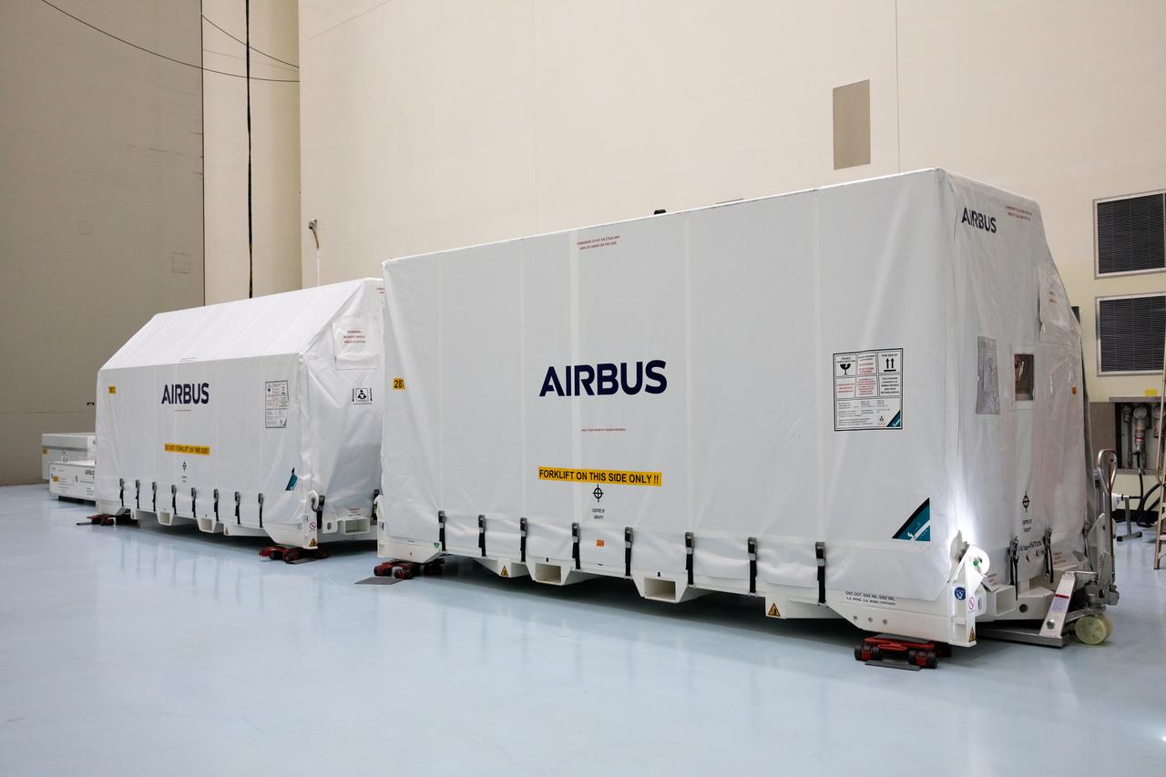 The transport carrier containing the five-panel solar arrays for NASA’s Europa Clipper spacecraft arrives at the Payload Hazardous Servicing Facility at the agency’s Kennedy Space Center in Florida on Wednesday, Feb. 21, 2024. The solar array travelled by air from Leiden, Netherlands, where Airbus workers assembled them over the last year, and then put on a barge to travel to the Port of Miami in Florida and loaded onto a semi-truck to be driven to Kennedy. The solar arrays will attach to the spacecraft to power it for the 1.8-billion-mile journey to study Jupiter’s icy moon, Europa. Launch on a SpaceX Falcon Heavy rocket is no earlier than October 2024.