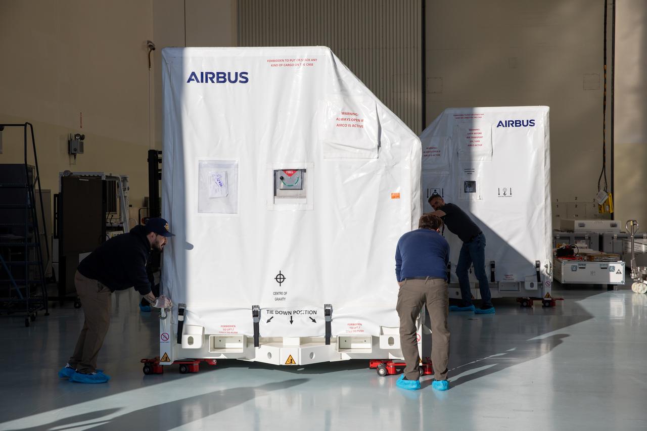 The transport carrier containing the five-panel solar arrays for NASA’s Europa Clipper spacecraft arrives at the Payload Hazardous Servicing Facility at the agency’s Kennedy Space Center in Florida on Wednesday, Feb. 21, 2024. The solar array travelled by air from Leiden, Netherlands, where Airbus workers assembled them over the last year, and then put on a barge to travel to the Port of Miami in Florida and loaded onto a semi-truck to be driven to Kennedy. The solar arrays will attach to the spacecraft to power it for the 1.8-billion-mile journey to study Jupiter’s icy moon, Europa. Launch on a SpaceX Falcon Heavy rocket is no earlier than October 2024.