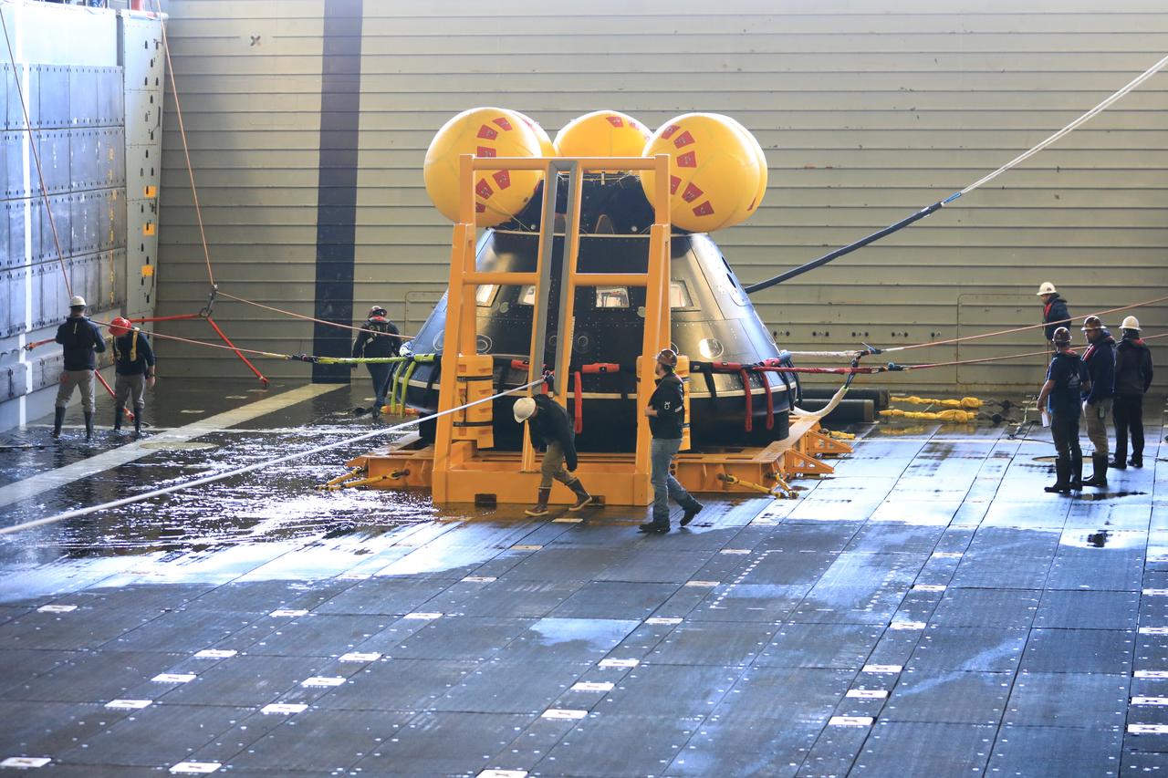 Members of NASA’s Exploration Ground System’s Landing and Recovery team and partners from the Department of Defense aboard the USS San Diego practice recovery procedures during Underway Recovery Test 11 (URT-11) off the coast of San Diego on Thursday, Feb. 22, 2024. The team works to secure the Crew Module Test Article and align it on its stand inside the ship’s well deck. URT-11 is the eleventh in a series of Artemis recovery tests, and the first time NASA and its partners put their Artemis II recovery procedures to the test with the astronauts.