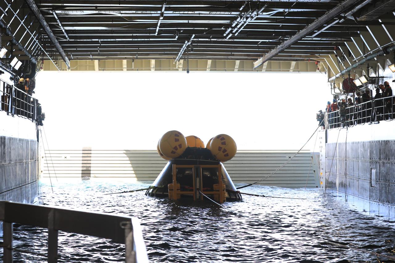 Members of NASA’s Exploration Ground System’s Landing and Recovery team and partners from the Department of Defense aboard the USS San Diego practice recovery procedures during Underway Recovery Test 11 (URT-11) off the coast of San Diego on Thursday, Feb. 22, 2024. The team works to secure the Crew Module Test Article and align it on its stand inside the ship’s well deck. URT-11 is the eleventh in a series of Artemis recovery tests, and the first time NASA and its partners put their Artemis II recovery procedures to the test with the astronauts.