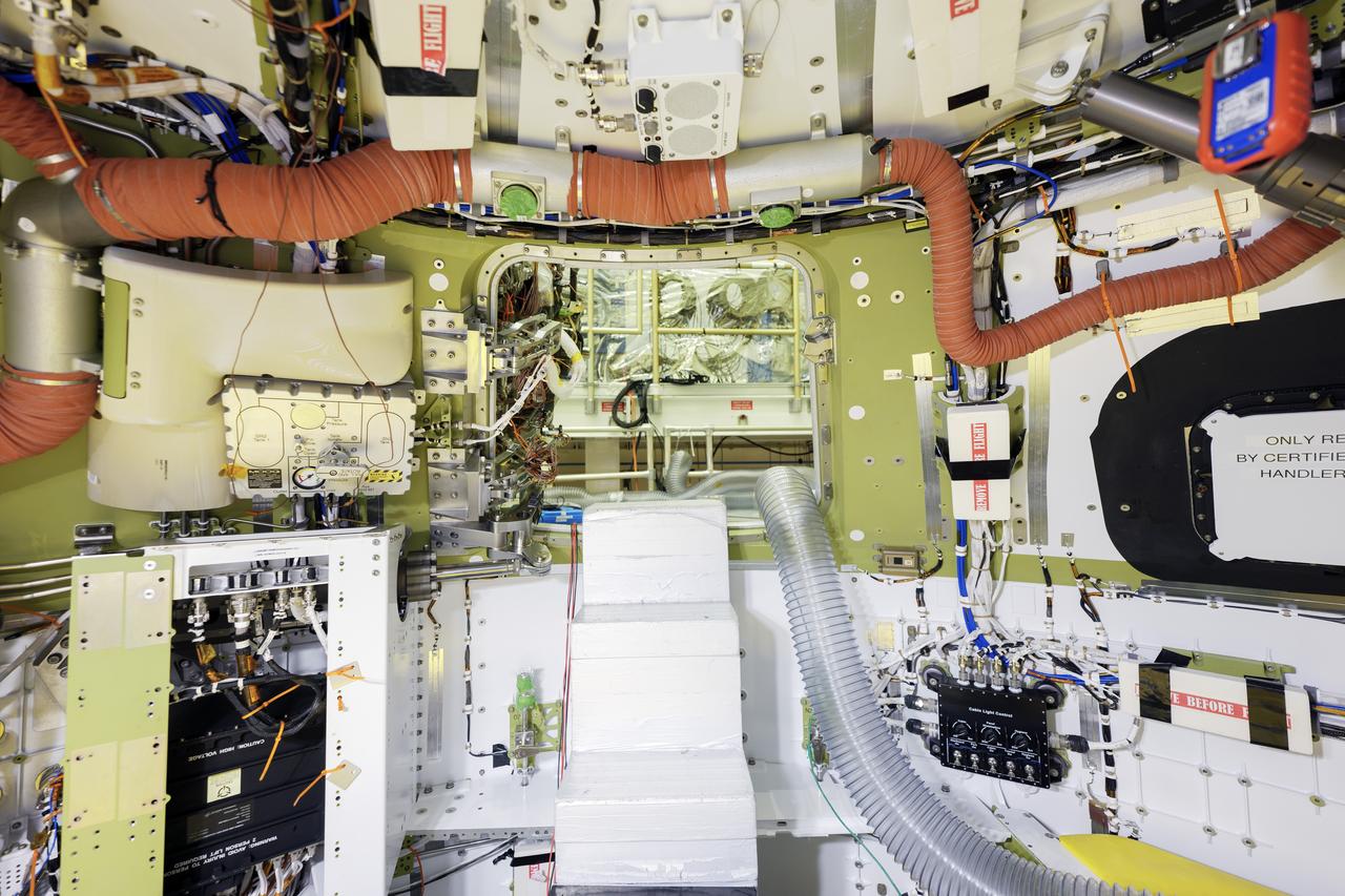 Teams inside the Operations and Checkout building at NASA’s Kennedy Space Center in Florida on Thursday, Feb. 1, 2024, work on the Orion spacecraft crew module  that will carry the Artemis II astronauts on their 10-day journey around the Moon.⁣  ⁣  Technicians are finalizing the crew cabin’s interior, and installing backshell panels and insulation on the spacecraft’s exterior that will protect Orion and the astronauts inside from the harsh environments they will encounter on their mission.⁣ 