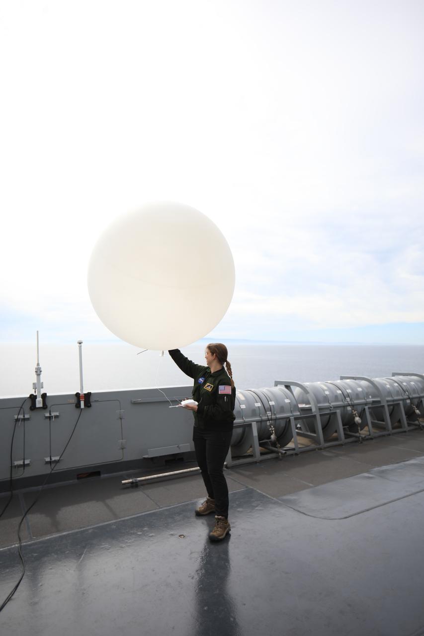Members of NASA’s Exploration Ground System’s Landing and Recovery team and partners from the Department of Defense aboard the USS San Diego release a weather balloon while practicing recovery procedures using the Crew Module Test Article during Underway Recovery Test 11 (URT-11) off the coast of San Diego on Saturday, Feb. 24, 2024. URT-11 is the eleventh in a series of Artemis recovery tests, and the first time NASA and its partners put their Artemis II recovery procedures to the test with the astronauts.