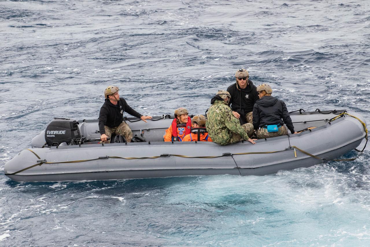 NASA’s Artemis II crew members ride in inflatable boats while NASA’s Exploration Ground System’s Landing and Recovery team and partners from the Department of Defense aboard the USS San Diego practice recovery procedures using the Crew Module Test Article, during Underway Recovery Test 11 (URT-11) off the coast of San Diego, California on Sunday, Feb. 25, 2024. URT-11 is the eleventh in a series of Artemis recovery tests, and the first time NASA and its partners put their Artemis II recovery procedures to the test with the astronauts.