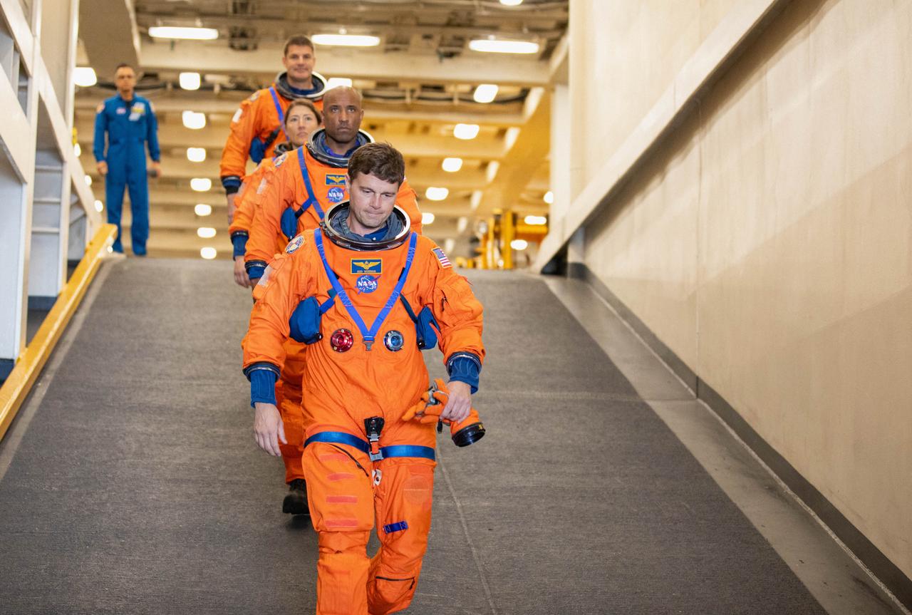 NASA’s Artemis II crew members (front to back) NASA astronauts Reid Wiseman, Victor Glover, and Christina Koch, and CSA (Canadian Space Agency) astronaut Jeremy Hansen descend the well deck of the USS San Diego as NASA’s Exploration Ground System’s Landing and Recovery team and partners from the Department of Defense aboard the ship practice recovery procedures using the Crew Module Test Article, during Underway Recovery Test 11 (URT-11) off the coast of San Diego, California on Sunday, Feb. 25, 2024. URT-11 is the eleventh in a series of Artemis recovery tests, and the first time NASA and its partners put their Artemis II recovery procedures to the test with the astronauts.