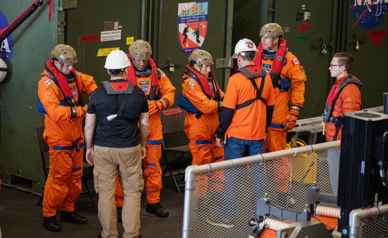 NASA’s Artemis II crew members (left to right) NASA astronauts Reid Wiseman, Victor Glover, and Christina Koch, and CSA (Canadian Space Agency) astronaut Jeremy Hansen finish suiting up in the well deck of the USS San Diego as NASA’s Exploration Ground System’s Landing and Recovery team and partners from the Department of Defense aboard the ship practice recovery procedures using the Crew Module Test Article, during Underway Recovery Test 11 (URT-11) off the coast of San Diego, California on Sunday, Feb. 25, 2024. URT-11 is the eleventh in a series of Artemis recovery tests, and the first time NASA and its partners put their Artemis II recovery procedures to the test with the astronauts.