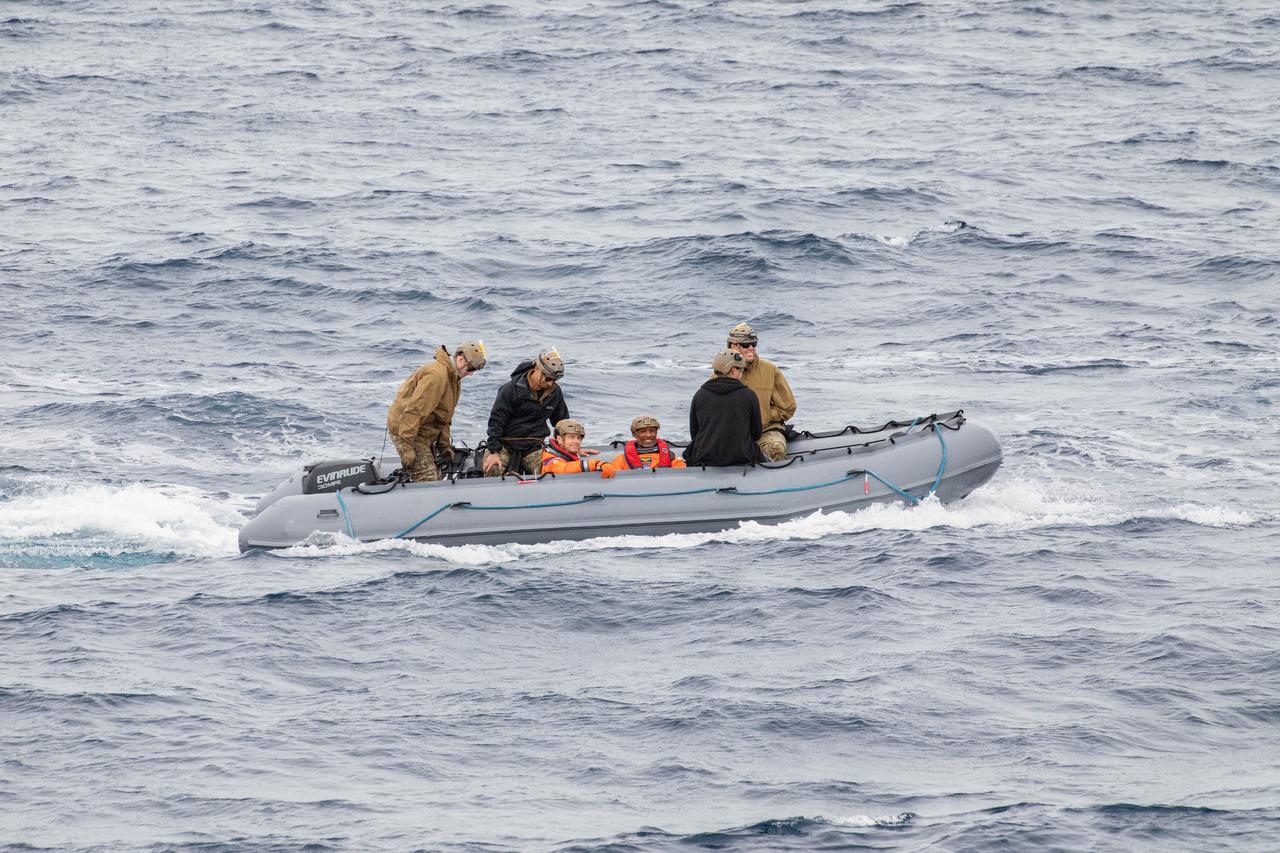 NASA’s Artemis II crew members ride in inflatable boats while NASA’s Exploration Ground System’s Landing and Recovery team and partners from the Department of Defense aboard the USS San Diego practice recovery procedures using the Crew Module Test Article, during Underway Recovery Test 11 (URT-11) off the coast of San Diego, California on Sunday, Feb. 25, 2024. URT-11 is the eleventh in a series of Artemis recovery tests, and the first time NASA and its partners put their Artemis II recovery procedures to the test with the astronauts.