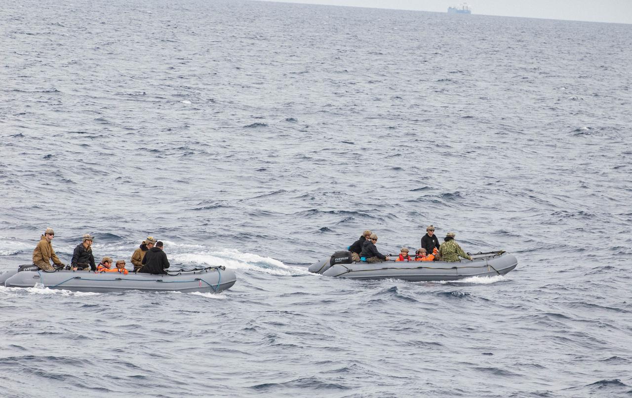 NASA’s Artemis II crew members ride in inflatable boats while NASA’s Exploration Ground System’s Landing and Recovery team and partners from the Department of Defense aboard the USS San Diego practice recovery procedures using the Crew Module Test Article, during Underway Recovery Test 11 (URT-11) off the coast of San Diego, California on Sunday, Feb. 25, 2024. URT-11 is the eleventh in a series of Artemis recovery tests, and the first time NASA and its partners put their Artemis II recovery procedures to the test with the astronauts.