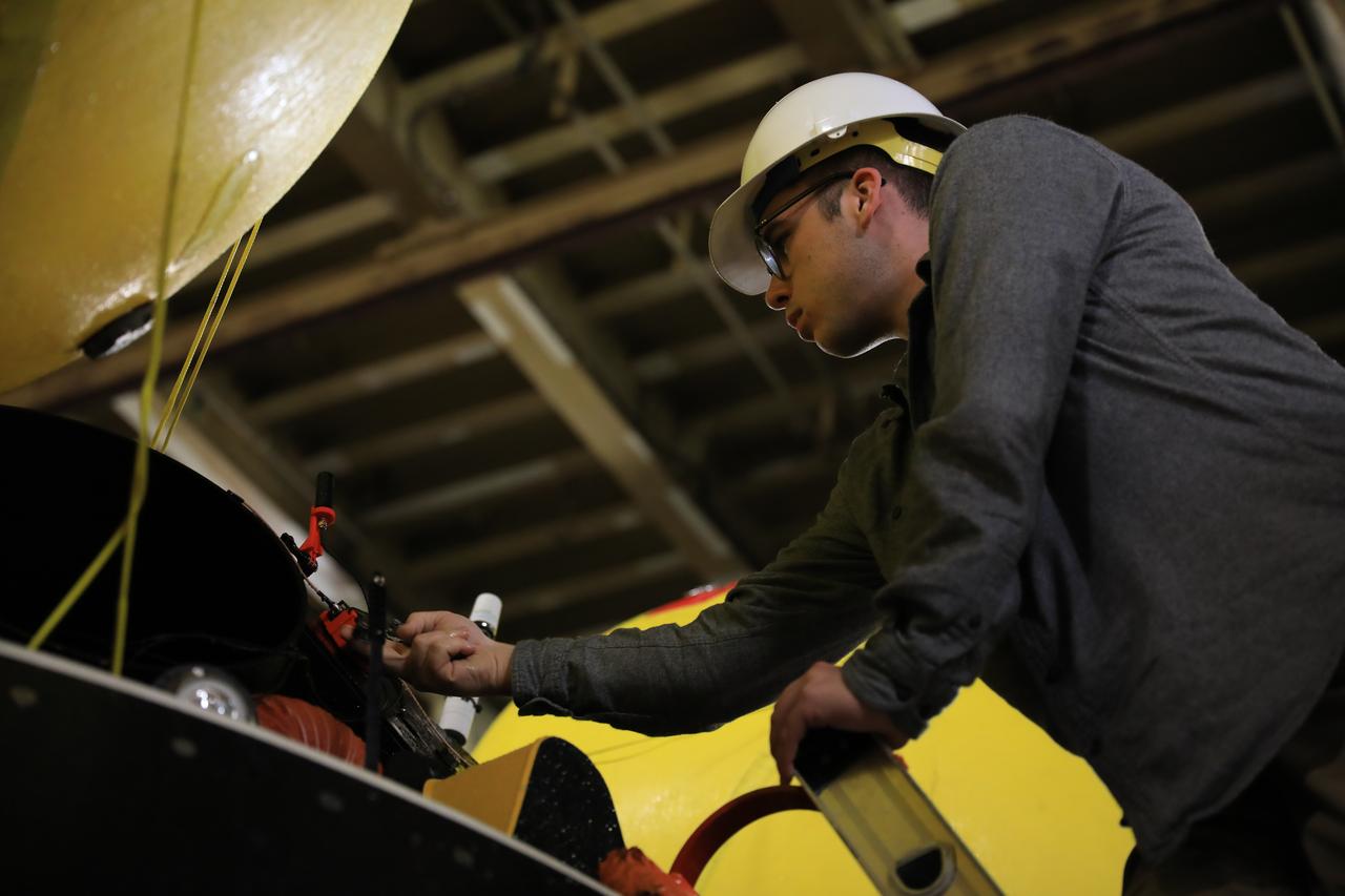 Members of NASA’s Exploration Ground System’s Landing and Recovery team aboard the USS San Diego pose in front of a mockup of the Orion spacecraft during Underway Recovery Test 11 (URT-11) off the coast of San Diego, California on Sunday, Feb. 25, 2024. URT-11 is the eleventh in a series of Artemis recovery tests, and the first time NASA and its partners put their Artemis II recovery procedures to the test with the astronauts. 