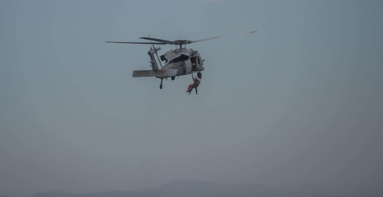Members of the United States Navy Helicopter Sea Combat Squadron (HSC) 23 "Wildcards" practice recovery procedures from a mockup of the Orion spacecraft in the Pacific Ocean during Underway Recovery Test 11 (URT-11) with NASA’s Exploration Ground System’s Landing and Recovery team and partners from the Department of Defense aboard the USS San Diego off the coast of San Diego on Sunday, Feb. 25, 2024. URT-11 is the eleventh in a series of Artemis recovery tests, and the first time NASA and its partners put their Artemis II recovery procedures to the test with the astronauts.