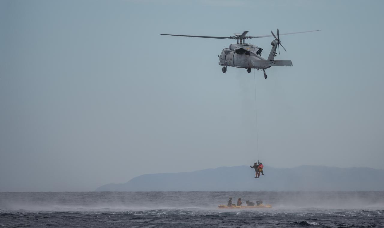 Members of the United States Navy Helicopter Sea Combat Squadron (HSC) 23 "Wildcards" practice recovery procedures from a mockup of the Orion spacecraft in the Pacific Ocean during Underway Recovery Test 11 (URT-11) with NASA’s Exploration Ground System’s Landing and Recovery team and partners from the Department of Defense aboard the USS San Diego off the coast of San Diego on Sunday, Feb. 25, 2024. URT-11 is the eleventh in a series of Artemis recovery tests, and the first time NASA and its partners put their Artemis II recovery procedures to the test with the astronauts.