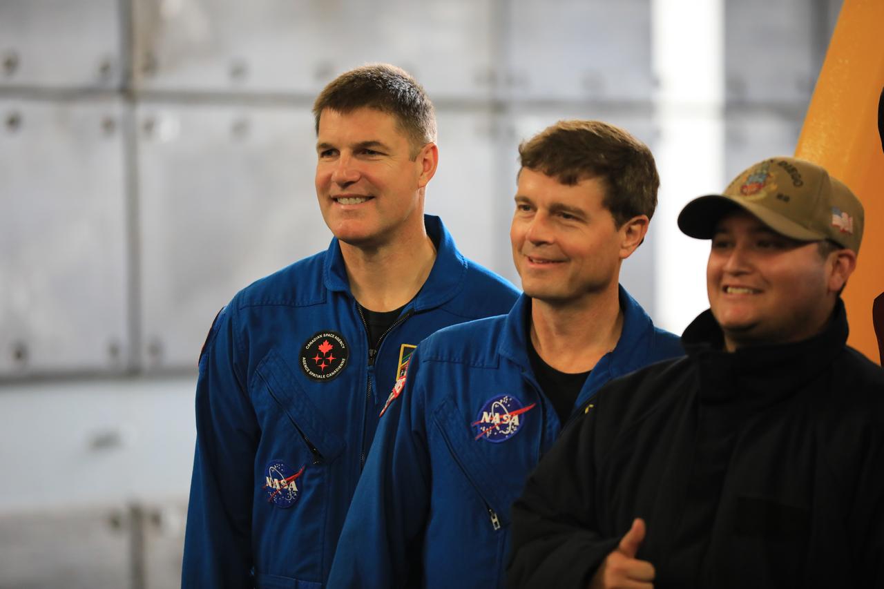 NASA’s Artemis II crew members (left to right) CSA (Canadian Space Agency) astronaut Jeremy Hansen, and NASA astronaut Reid Wiseman and a member of the USS San Diego pose for a photograph during Underway Recovery Test 11 (URT-11), off the coast of San Diego, California on Monday, Feb. 26, 2024. URT-11 is the eleventh in a series of Artemis recovery tests, and the first time NASA and its partners put their Artemis II recovery procedures to the test with the astronauts.