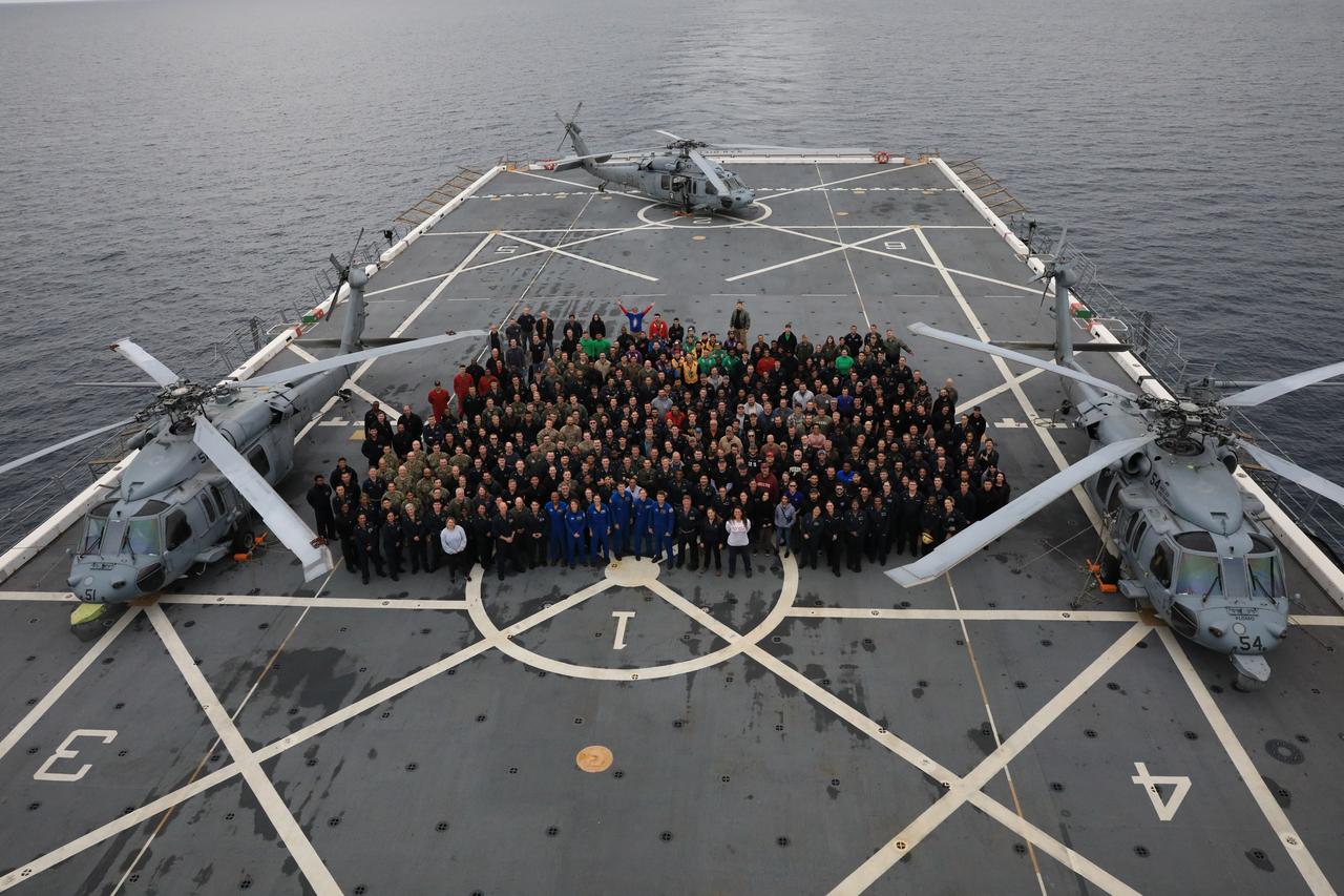 NASA Artemis II astronauts, members of NASA’s Exploration Ground System’s Landing and Recovery team, U.S. Navy personnel, and others aboard the USS San Diego pose for a photo during Underway Recovery Test 11 (URT-11) off the coast of San Diego, California on Monday, Feb. 26, 2024. URT-11 is the eleventh in a series of Artemis recovery tests, and the first time NASA and its partners put their Artemis II recovery procedures to the test with the astronauts. 
