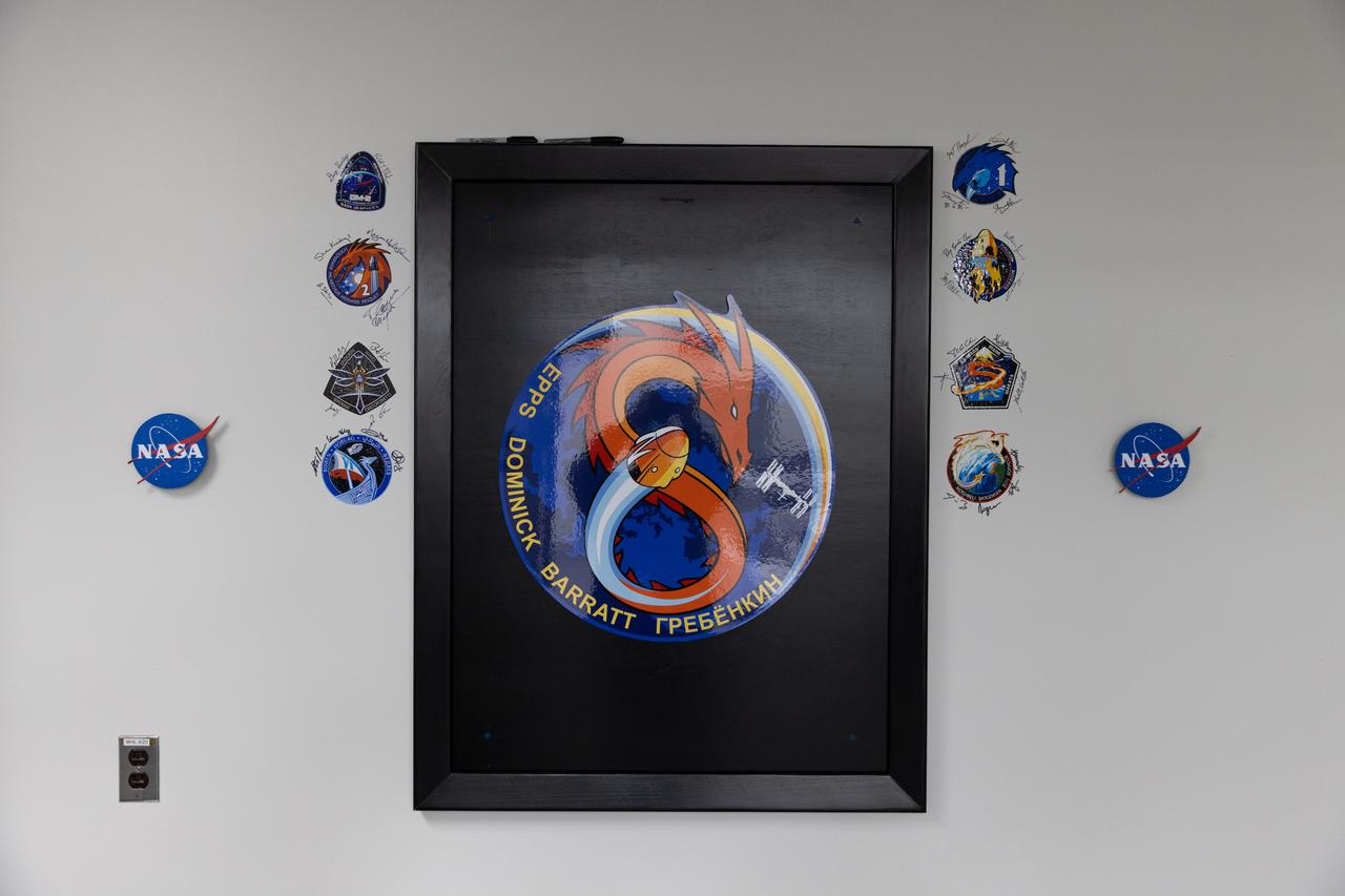 The signatures of NASA astronauts Michael Barratt, Matthew Dominick, and Jeanette Epps, along with Roscosmos cosmonaut Alexander Grebenkin are photographed alongside NASA’s SpaceX Crew-8 mission insignia inside the Astronaut Crew Quarters in the Neil A. Armstrong Operations and Checkout Building at NASA’s Kennedy Space Center in Florida on Monday, February 26, 2024. NASA’s SpaceX Crew-8 mission is the eighth crew rotation mission of the SpaceX Dragon spacecraft and Falcon 9 rocket to the International Space Station as part of the agency’s Commercial Crew Program and is scheduled to launch at 12:04 a.m. EST on Friday, March 1, from Launch Complex 39A at the Kennedy Space Center. 