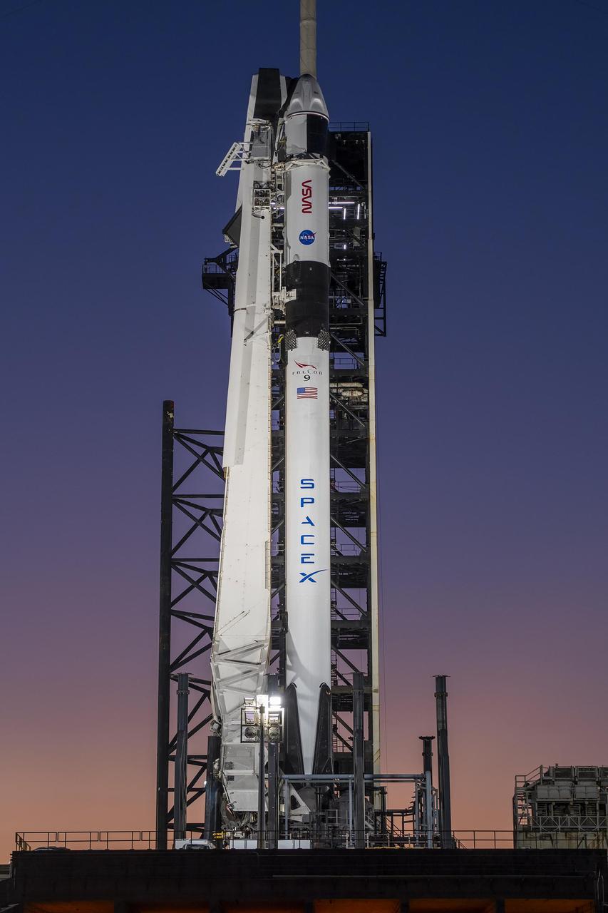 A colorful sunset serves as the backdrop for SpaceX’s Falcon 9 rocket and Dragon spacecraft on the pad at Launch Complex 39A at Kennedy Space Center in Florida on Monday, Feb. 26, 2024, ahead of NASA’s SpaceX Crew-8 mission. The crew members of NASA’s SpaceX Crew-8 mission, NASA astronauts Matthew Dominick, Michael Barratt, and Jeanette Epps, and Roscosmos cosmonaut Alexander Grebenkin, are slated to launch to the International Space Station no earlier than 12:04 a.m. EST on Friday, March 1, from Launch Complex 39A.