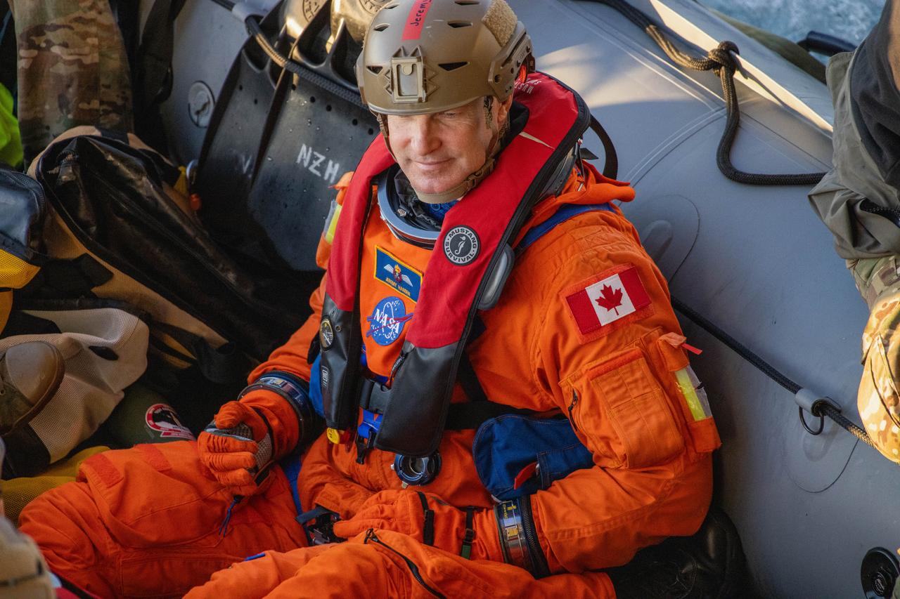 NASA’s Artemis II crew member CSA (Canadian Space Agency) astronaut Jeremy Hansen sits in a boat following practice recovery procedures during Underway Recovery Test 11 (URT-11) off the coast of San Diego, California on Tuesday, Feb. 27, 2024. URT-11 is the eleventh in a series of Artemis recovery tests, and the first time NASA and its partners put their Artemis II recovery procedures to the test with the astronauts.
