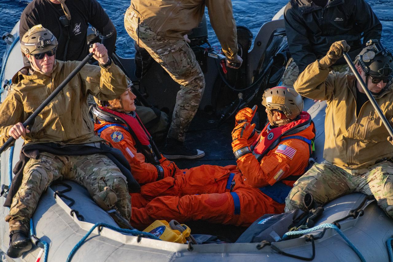 NASA’s Exploration Ground System’s Landing and Recovery team, partners from the Department of Defense, and U.S. Navy personnel aboard the USS San Diego assist NASA’s Artemis II crew members from left to right NASA astronauts Christina Koch and Victor Glover from a boat during practice recovery procedures during Underway Recovery Test 11 (URT-11) off the coast of San Diego, California on Tuesday, Feb. 27, 2024. URT-11 is the eleventh in a series of Artemis recovery tests, and the first time NASA and its partners put their Artemis II recovery procedures to the test with the astronauts.