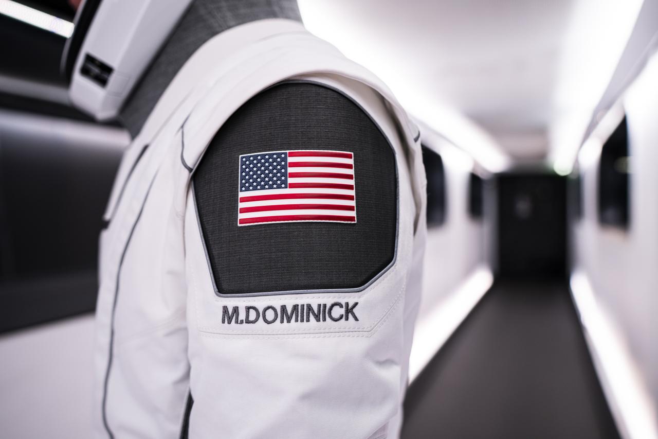 A SpaceX launch and entry suit bears an American flag and the name of NASA astronaut Matthew Dominick, who will serve as the commander of NASA's SpaceX Crew-8 mission to the International Space as part of the agency’s Commercial Crew Program. Liftoff from Launch Complex 39A at the agency’s Kennedy Space Center in Florida is scheduled for 12:04 a.m. EST on Friday, March 1, 2024.