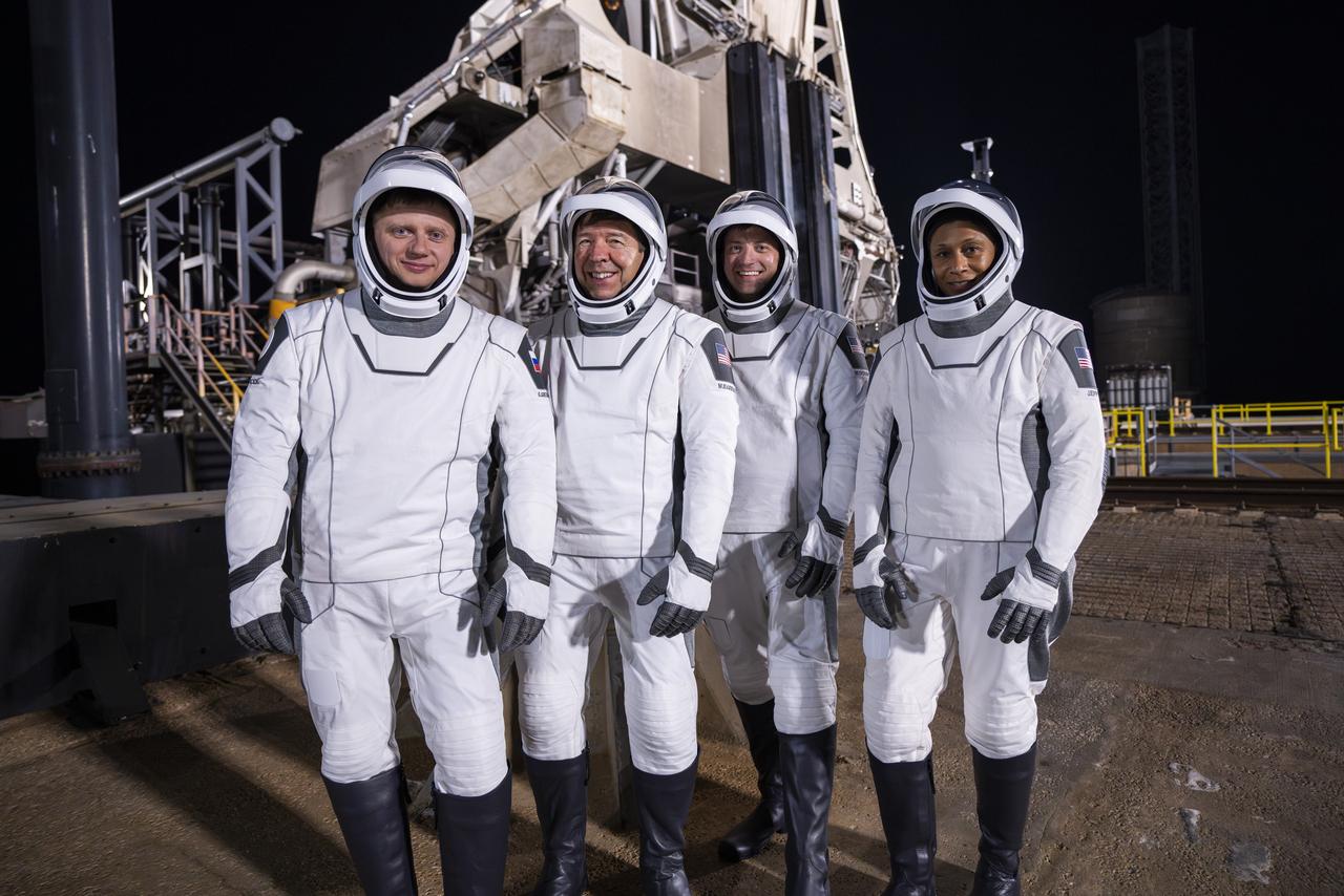 Members of NASA’s SpaceX Crew-8 from right to left, NASA astronauts Jeanette Epps, mission specialist; Matthew Dominick, commander; Michael Barratt, pilot; and Roscosmos cosmonaut Alexander Grebenkin, mission specialist; are photographed in their spacesuits at Launch Complex 39A in front of SpaceX’s Falcon 9 rocket and Dragon spacecraft during a dress rehearsal on Monday, Feb. 26, 2024, in preparation for the Crew-8 mission at NASA’s Kennedy Space Center in Florida. NASA’s SpaceX Crew-8 is the eighth crew rotation mission with SpaceX to the station and the ninth flight of Dragon with people as part of the agency’s Commercial Crew Program. Liftoff from Launch Complex 39A is scheduled for 12:04 a.m. EST on Friday, March 1. 