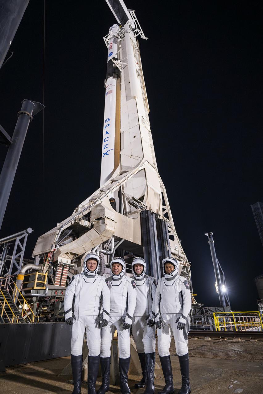 Members of NASA’s SpaceX Crew-8 from right to left, NASA astronauts Jeanette Epps, mission specialist; Matthew Dominick, commander; Michael Barratt, pilot; and Roscosmos cosmonaut Alexander Grebenkin, mission specialist; are photographed in their spacesuits at Launch Complex 39A in front of SpaceX’s Falcon 9 rocket and Dragon spacecraft during a dress rehearsal on Monday, Feb. 26, 2024, in preparation for the Crew-8 mission at NASA’s Kennedy Space Center in Florida. NASA’s SpaceX Crew-8 is the eighth crew rotation mission with SpaceX to the station and the ninth flight of Dragon with people as part of the agency’s Commercial Crew Program. Liftoff from Launch Complex 39A is scheduled for 12:04 a.m. EST on Friday, March 1. 