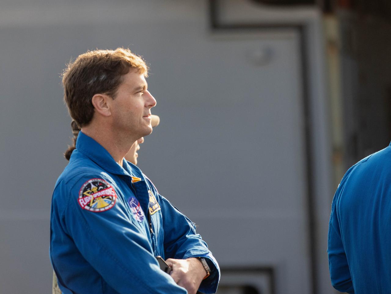 NASA’s Artemis II crew member NASA astronaut Reid Wiseman observes a news conference discussing the practice recovery procedures following the Underway Recovery Test (URT-11) aboard the USS San Diego on Wednesday, Feb. 28, 2024. URT-11 performed by NASA’s Exploration Ground System’s Landing and Recovery team, partners from the Department of Defense, and U.S. Navy personnel aboard the USS San Diego is the eleventh in a series of Artemis recovery tests, and the first the Artemis II recovery procedures involved the astronauts.