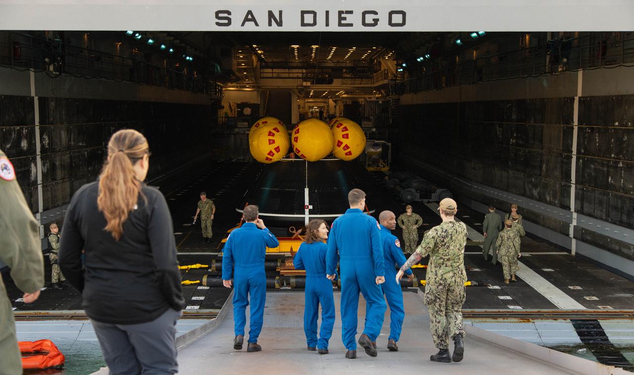 NASA’s Artemis II crew members from left to right, NASA astronauts Reid Wiseman, Christina Koch, and CSA (Canadian Space Agency) astronaut Jeremy Hansen, and NASA astronaut Victor Glover walk toward the USS San Diego and approach a mockup of the Orion spacecraft in San Diego, California on Wednesday, Feb. 28, 2024, as part of the Underway Recovery Test (URT-11). URT-11 performed by NASA’s Exploration Ground System’s Landing and Recovery team, partners from the Department of Defense, and U.S. Navy personnel aboard the USS San Diego is the eleventh in a series of Artemis recovery tests, and the first the Artemis II recovery procedures involved the astronauts.