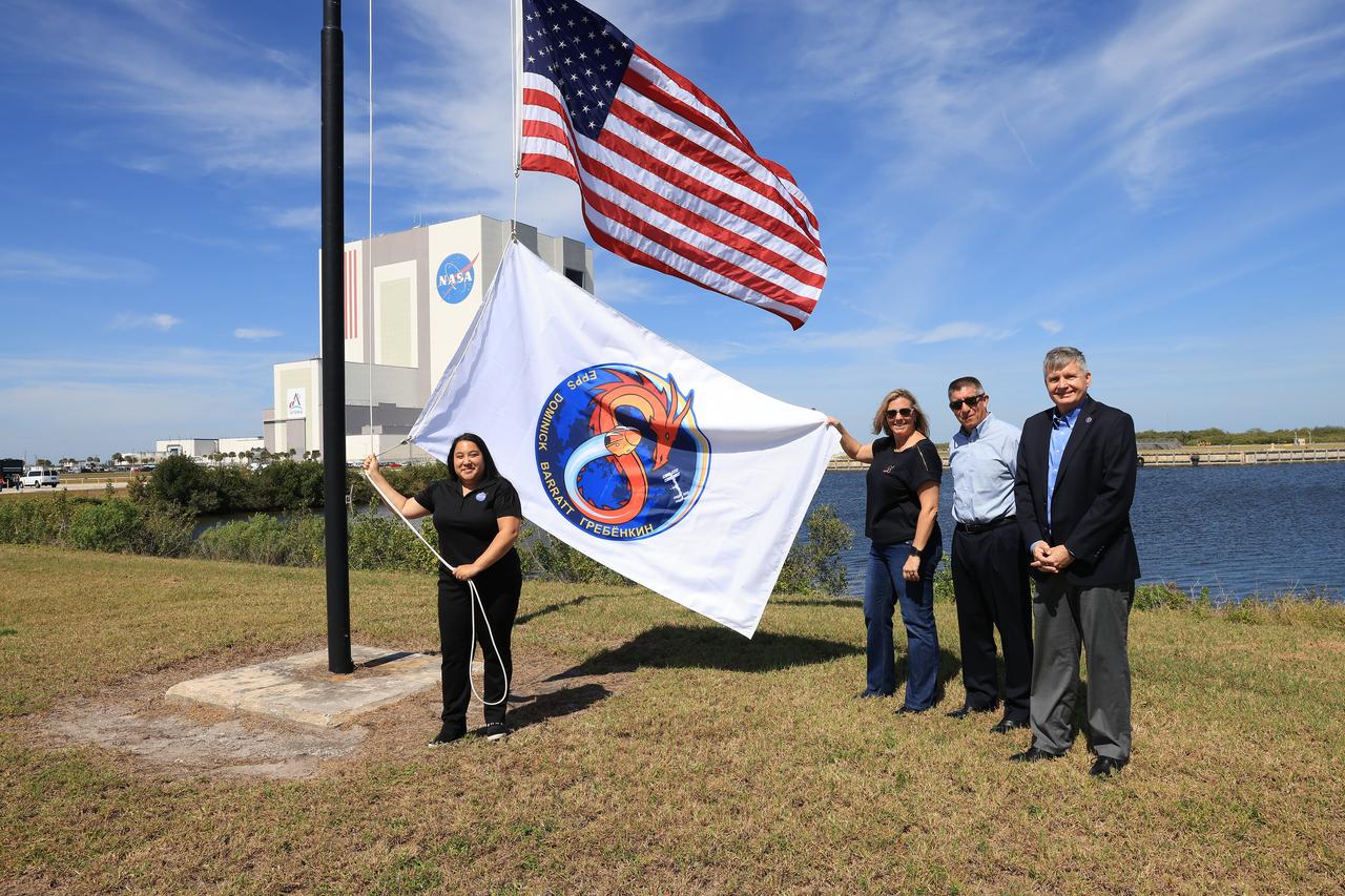 NASA’s SpaceX Crew-8 flag is raised, Wednesday, Feb. 28, 2024, near the countdown clock at the NASA News Center at the agency’s Kennedy Space Center in Florida. The Crew-8 mission will send NASA astronauts Matthew Dominick, Michael Barratt, and Jeanette Epps, and Roscosmos cosmonaut Alexander Grebenkin, to the International Space Station aboard SpaceX’s Dragon spacecraft on the company’s Falcon 9 rocket from Kennedy’s Launch Complex 39A no earlier than 11:16 p.m. EDT Saturday, March 2.