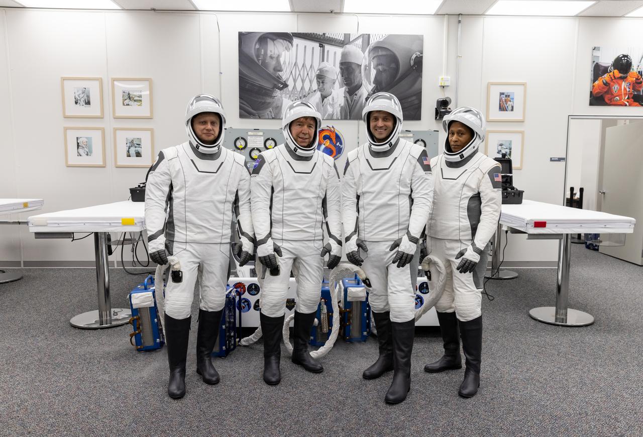 Members of NASA’s SpaceX Crew-8 from right to left are NASA astronauts Jeanette Epps, Matthew Dominick, Michael Barratt, and Roscosmos cosmonaut Alexander Grebenkin smile and pose for a photo in the suit-up room in the Astronaut Crew Quarters inside Kennedy Space Center’s Neil A. Armstrong Operations and Checkout Building before launch on Saturday, March 2, 2024. During suit-up, a team of SpaceX suit technicians assist the crew as they put on their custom-fitted spacesuits and perform leak checks. As part of NASA’s Commercial Crew Program, the Crew-8 crew members are scheduled to launch aboard SpaceX’s Dragon spacecraft and Falcon 9 rocket to the International Space Station 10:53 p.m. EST Sunday, March 3, 2024, from Kennedy’s Launch Complex 39A.
