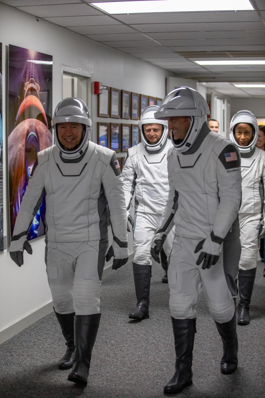 NASA’s SpaceX Crew-8 crew members walk out of the Neil A. Armstrong Operations and Checkout Building on Sunday, March 3,2024, at the agency’s Kennedy Space Center in Florida. In front from right to left, NASA astronauts Matthew Dominick, Michael Barratt, and Jeanette Epps, and Roscosmos cosmonaut Alexander Grebenkin on their way to load up into waiting vehicles for the trip to Kennedy’s Launch Complex 39A, where they will launch to the International Space Station aboard SpaceX’s Dragon spacecraft atop the Falcon 9 rocket 10:53 p.m. EST on Sunday, March 3, 2024.
