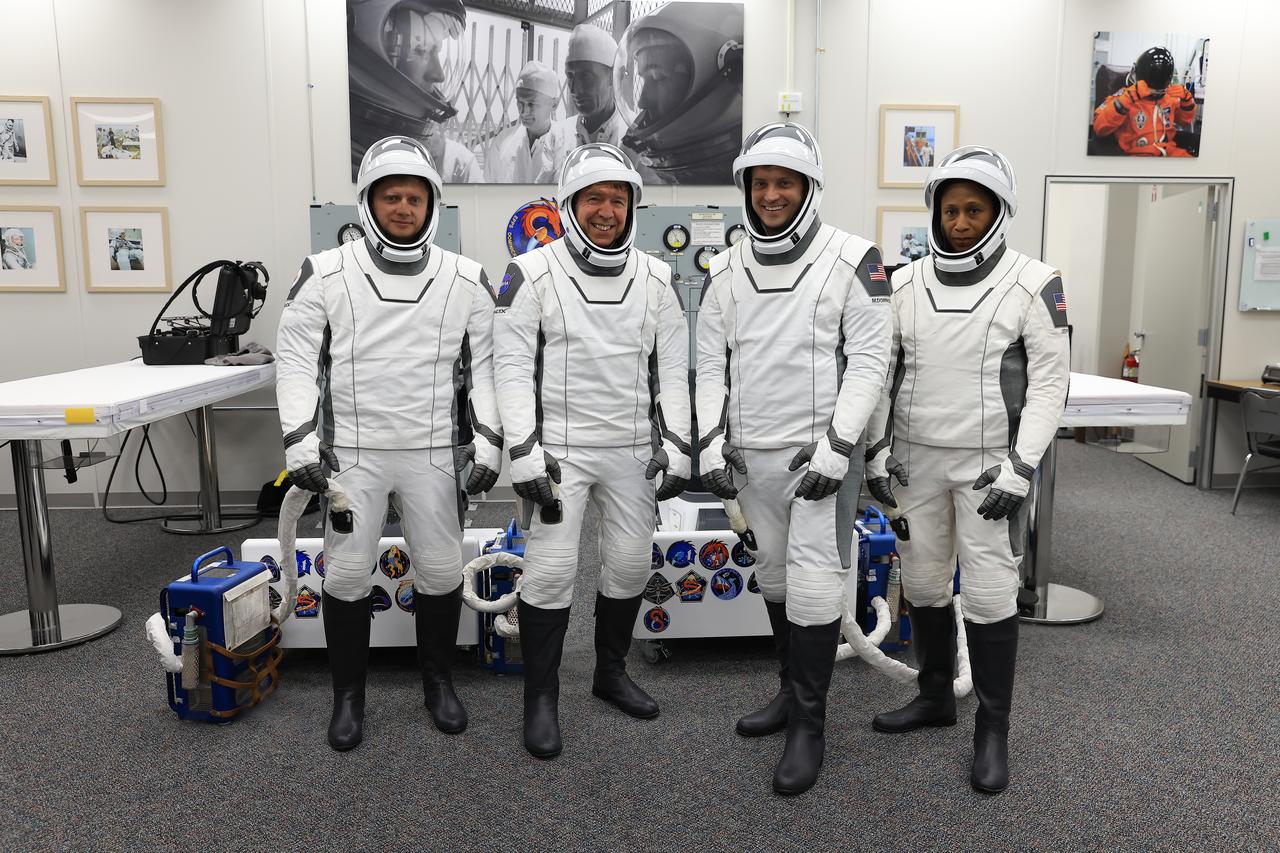 Members of NASA’s SpaceX Crew-8 from right to left are NASA astronauts Jeanette Epps, Matthew Dominick, Michael Barratt, and Roscosmos cosmonaut Alexander Grebenkin smile and pose for a photo in the suit-up room in the Astronaut Crew Quarters inside Kennedy Space Center’s Neil A. Armstrong Operations and Checkout Building before launch on Sunday, March 3, 2024. During suit-up, a team of SpaceX suit technicians assist the crew as they put on their custom-fitted spacesuits and perform leak checks. As part of NASA’s Commercial Crew Program, the Crew-8 crew members are scheduled to launch aboard SpaceX’s Dragon spacecraft and Falcon 9 rocket to the International Space Station 10:53 p.m. EST Sunday, March 3, 2024, from Kennedy’s Launch Complex 39A.