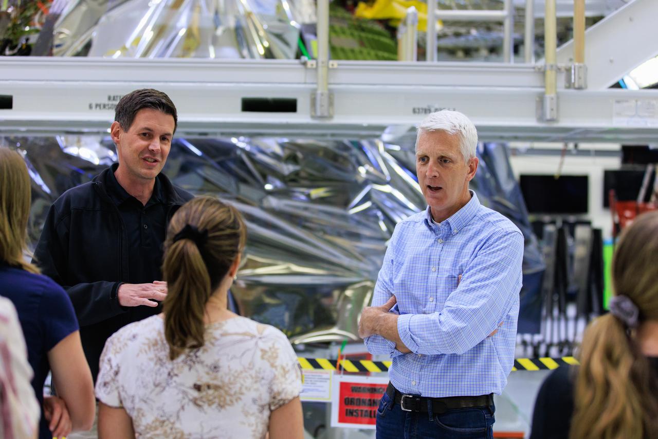 Nathan Varn, Program Director Orion Productions for Lockheed Martin, left, and Scott Wilson, NASA’s Division Chief, Orion Production Operations Office, lead a tour for Artemis II crew members and their families of the Neil A. Armstrong Operations and Checkout Building at NASA’s Kennedy Space Center in Florida, on Friday, March 15, 2024. Artemis II Commander Reid Wiseman and Artemis II Mission Specialist Jeremy Hansen toured the facility with their families and viewed the Orion crew modules, including the spacecraft that will take them, along with Artemis II Pilot Victor Glover and Artemis II Mission Specialist Christina Hammock Koch, around the Moon and back during the Artemis II mission. 