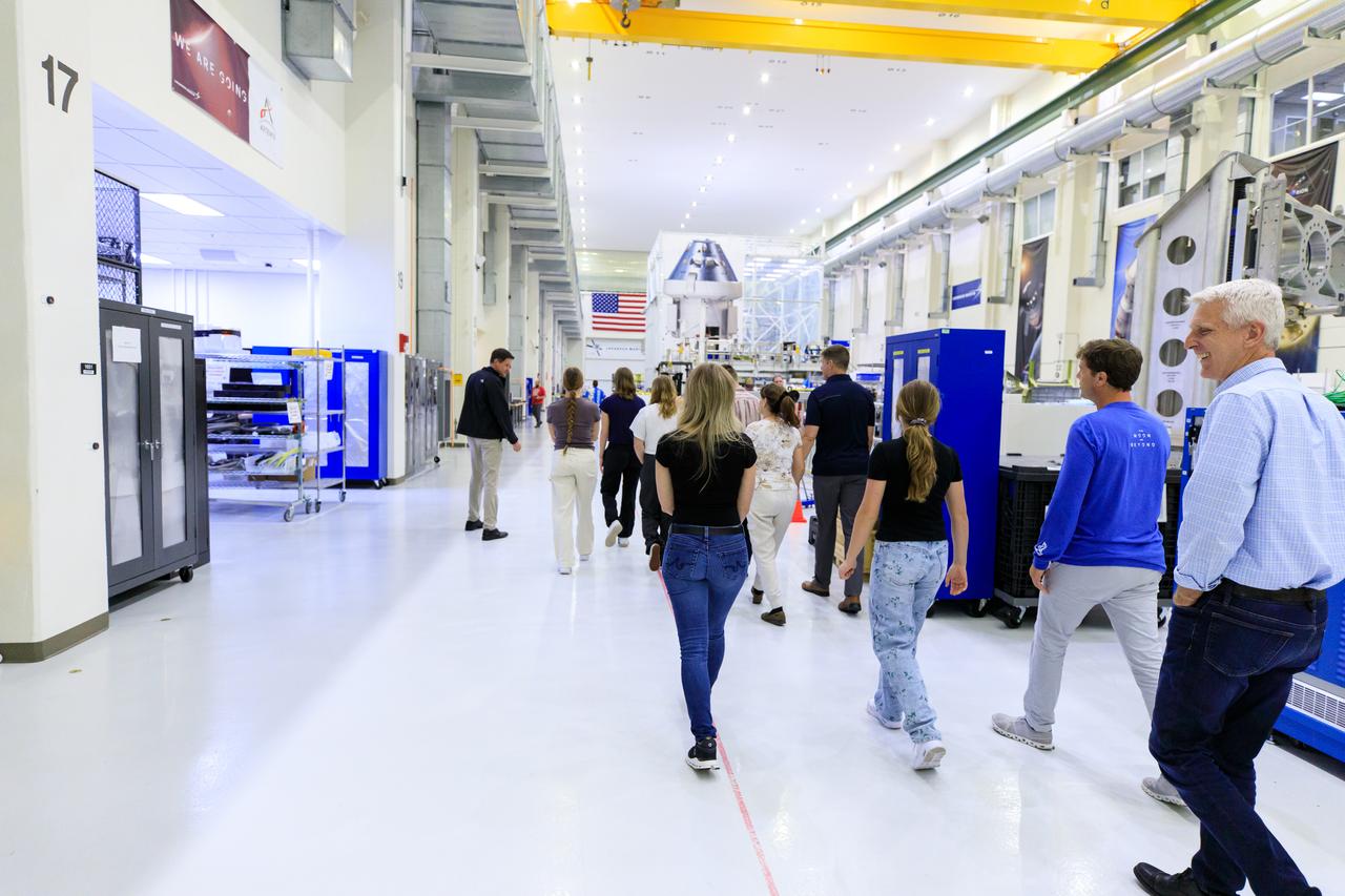 Nathan Varn, far left, Program Director Orion Productions for Lockheed Martin, and Scott Wilson, far right, NASA’s Division Chief, Orion Production Operations Office, lead a tour for Artemis II crew members and their families of the Neil A. Armstrong Operations and Checkout Building at NASA’s Kennedy Space Center in Florida, on Friday, March 15, 2024. Artemis II Commander Reid Wiseman and Artemis II Mission Specialist Jeremy Hansen toured the facility with their families and viewed the Orion crew modules, including the spacecraft that will take them, along with Artemis II Pilot Victor Glover and Artemis II Mission Specialist Christina Hammock Koch, around the Moon and back during the Artemis II mission.