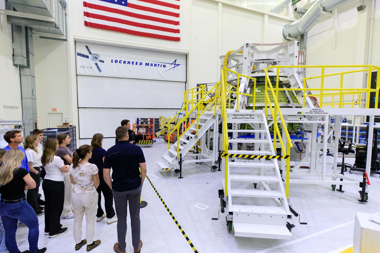 Nathan Varn, Program Director Orion Productions for Lockheed Martin, discusses the Orion crew spacecraft for Artemis III during a tour for Artemis II crew members and their families of the Neil A. Armstrong Operations and Checkout Building at NASA’s Kennedy Space Center in Florida, on Friday, March 15, 2024. Artemis II Commander Reid Wiseman and Artemis II Mission Specialist Jeremy Hansen toured the facility with their families and viewed the Orion spacecraft for upcoming Artemis missions. 
